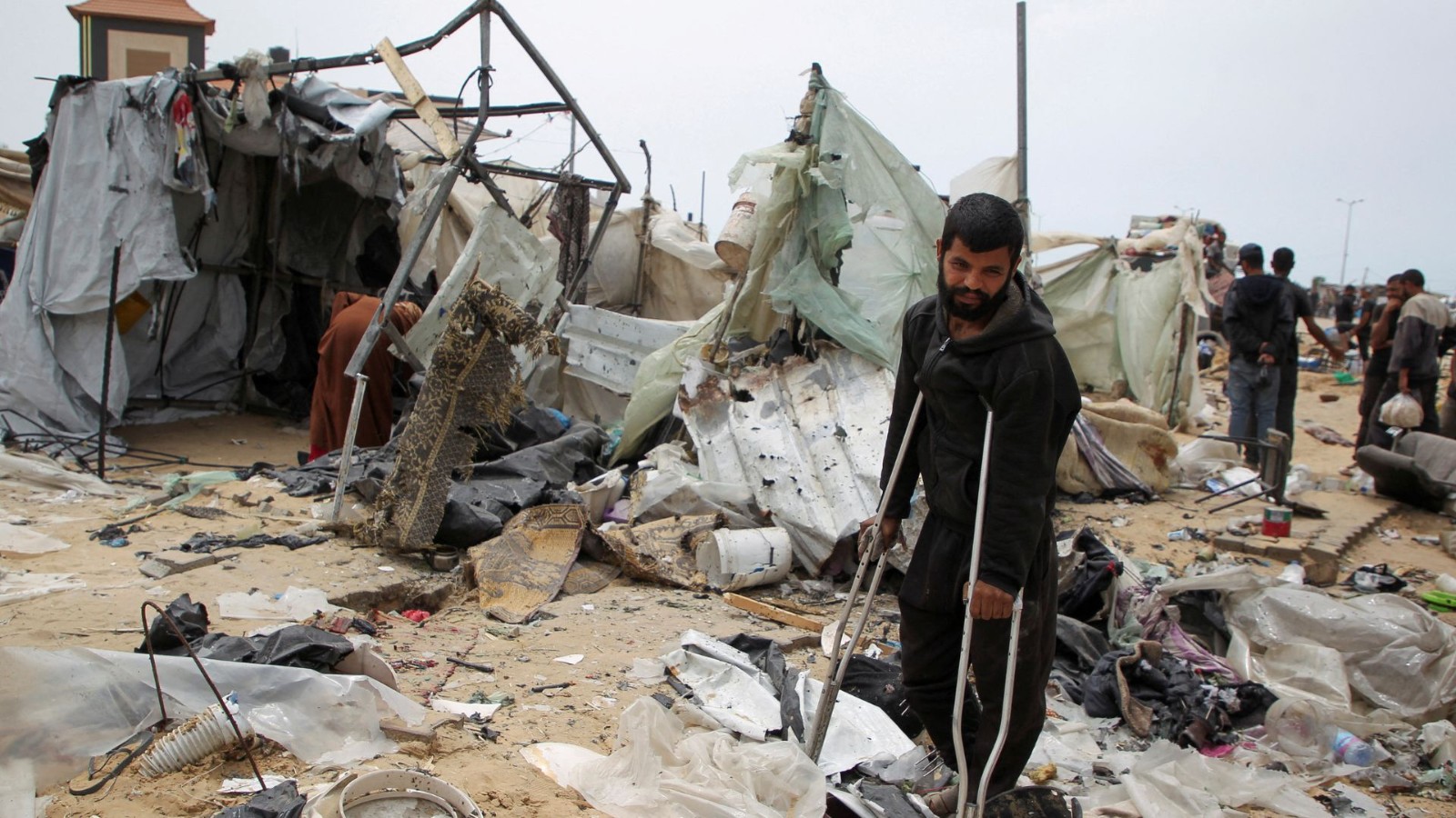 Palestinians inspect a tent camp damaged in an Israeli strike on Rafah. /Hatem Khaled/Reuters
