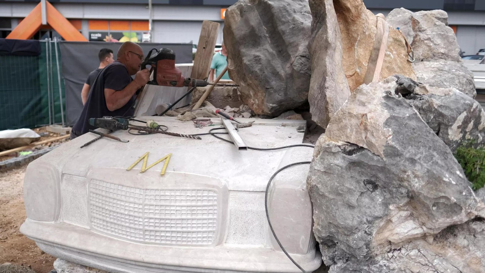 Mislav Rebic works on the Mercedes-Benz statue in the Croatian town of Imotski. /Filip Babic/AFP