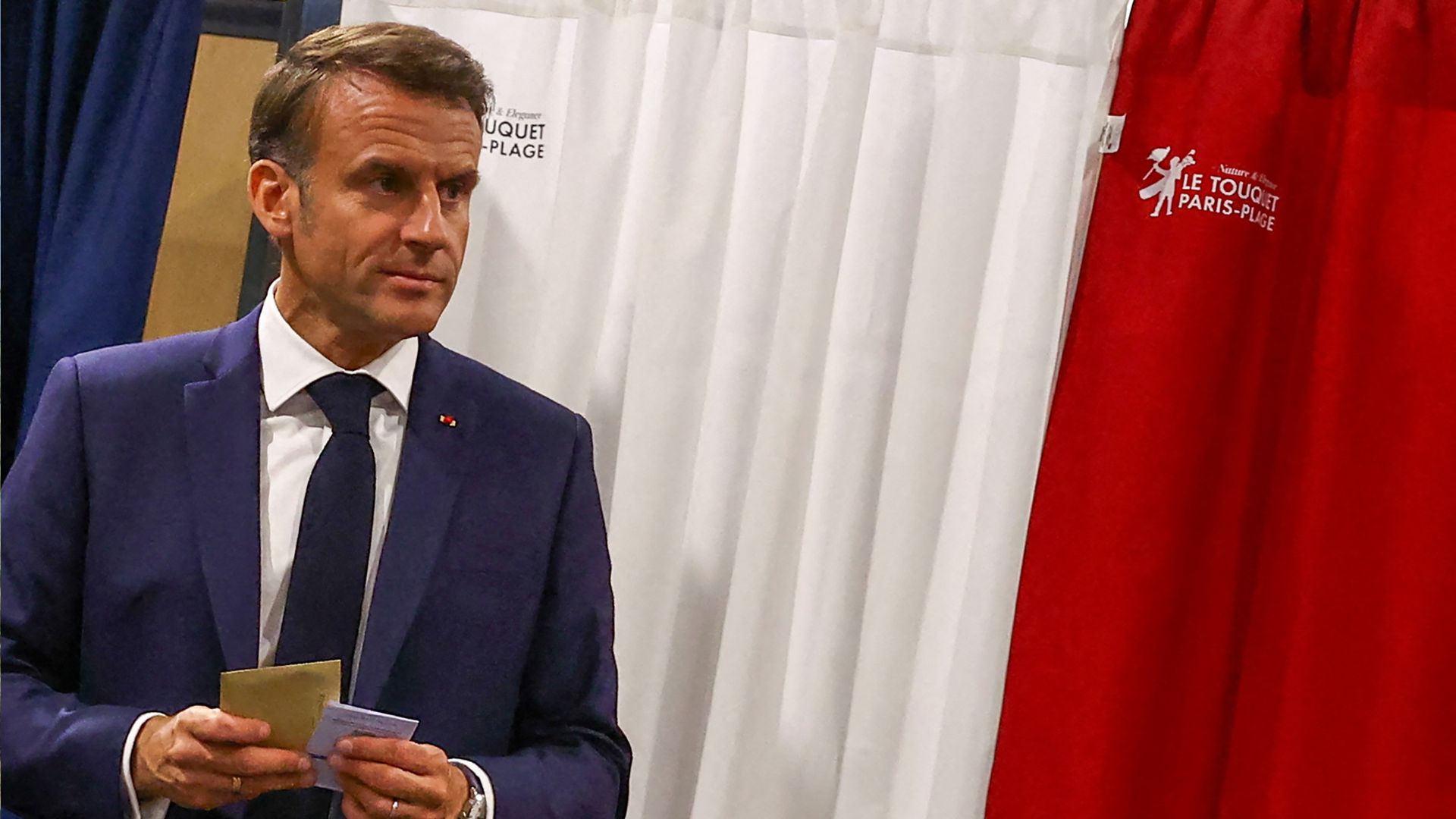 Macron exits a polling booth before casting his ballot for the European Parliament election at a polling station in Le Touquet.
/Hannah McKay/Pool/AFP