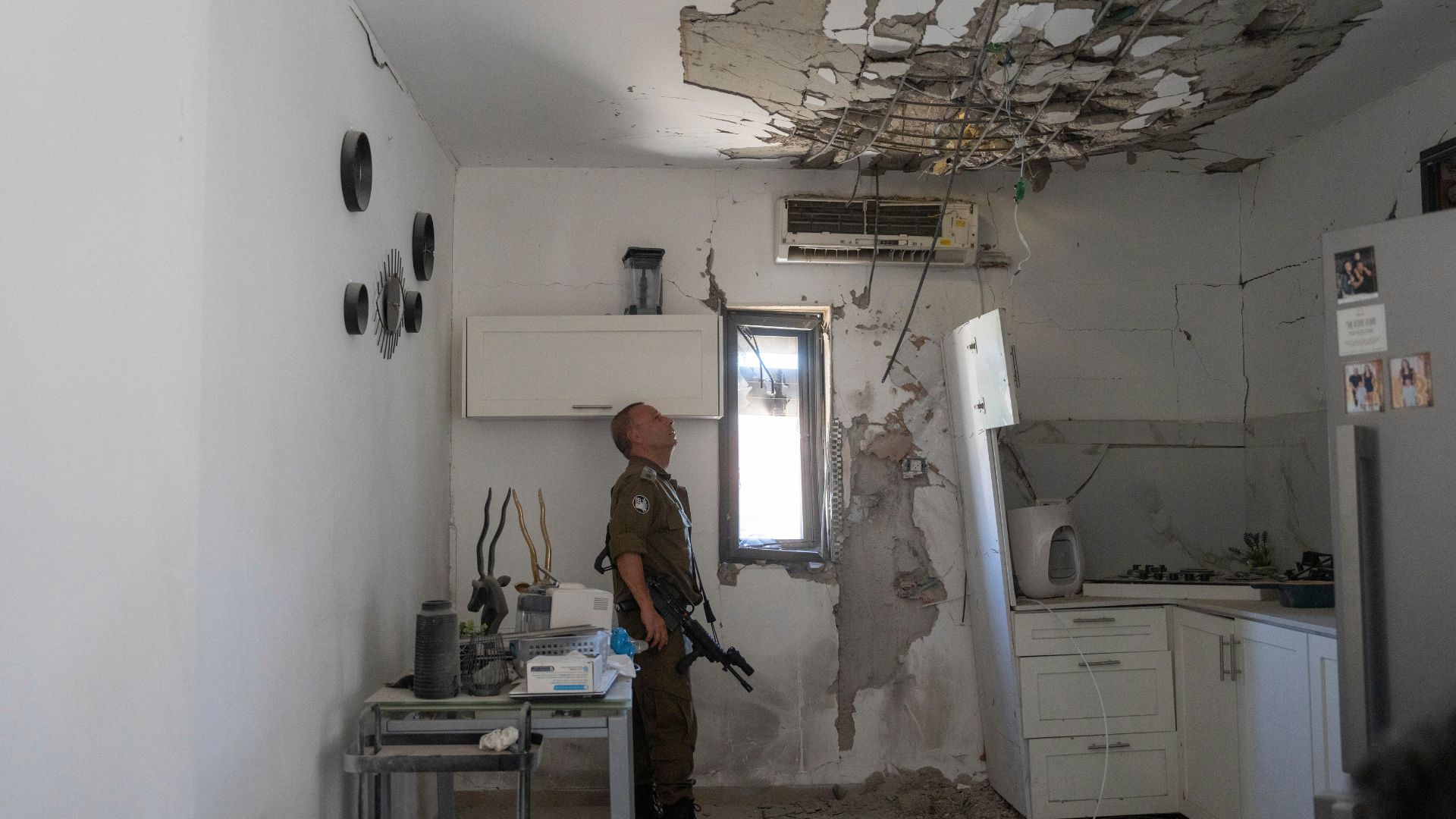 An Israeli army officer shows damage inside a house in the city of Kiryat Shmona, Israel, which was hit by a missile fired from Lebanon few weeks ago, on Sunday, June 16, 2024. /Ohad Zwigenberg/AP Photo