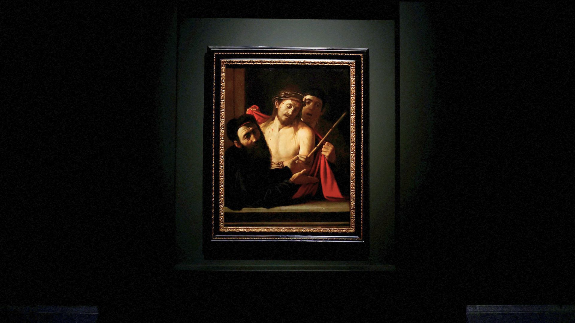 Caravaggio's 'Ecce Homo' is displayed on a pitch-black wall in Madrid's El Prado Museum. /Susana Vera/Reuters