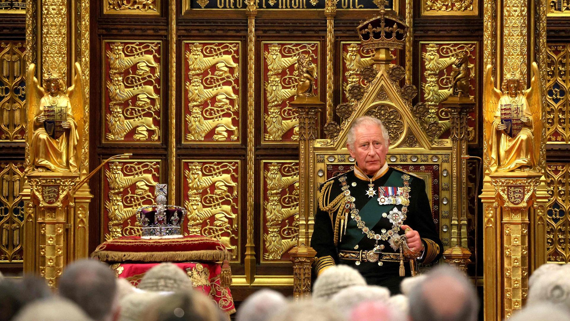 King (then Prince) Charles sits by the The Imperial State Crown (L) in the House of Lords Chamber during the State Opening of Parliament in May 2022. /Dan Kitwood/Pool
