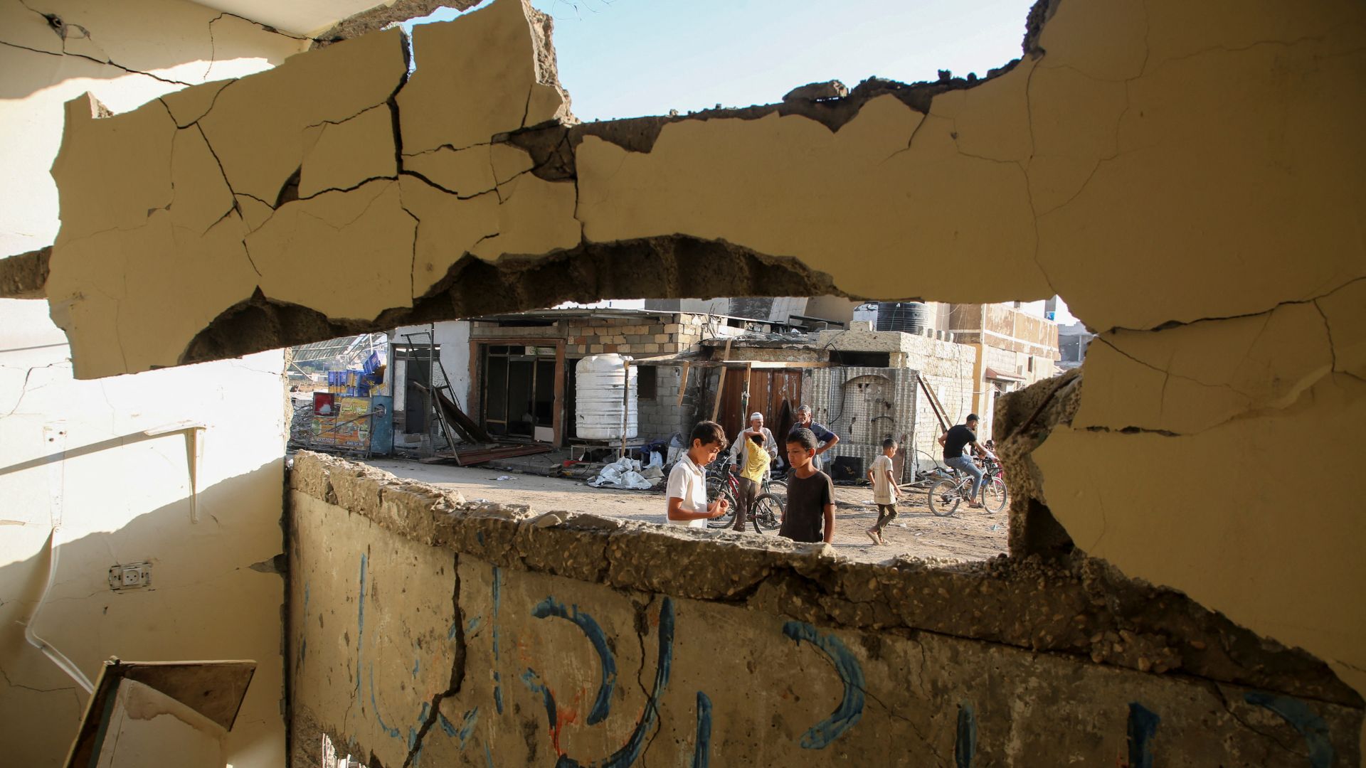 A damaged wall at the site of an Israeli strike outside a school sheltering displaced people in Khan Younis. /Hatem Khaled/Reuters