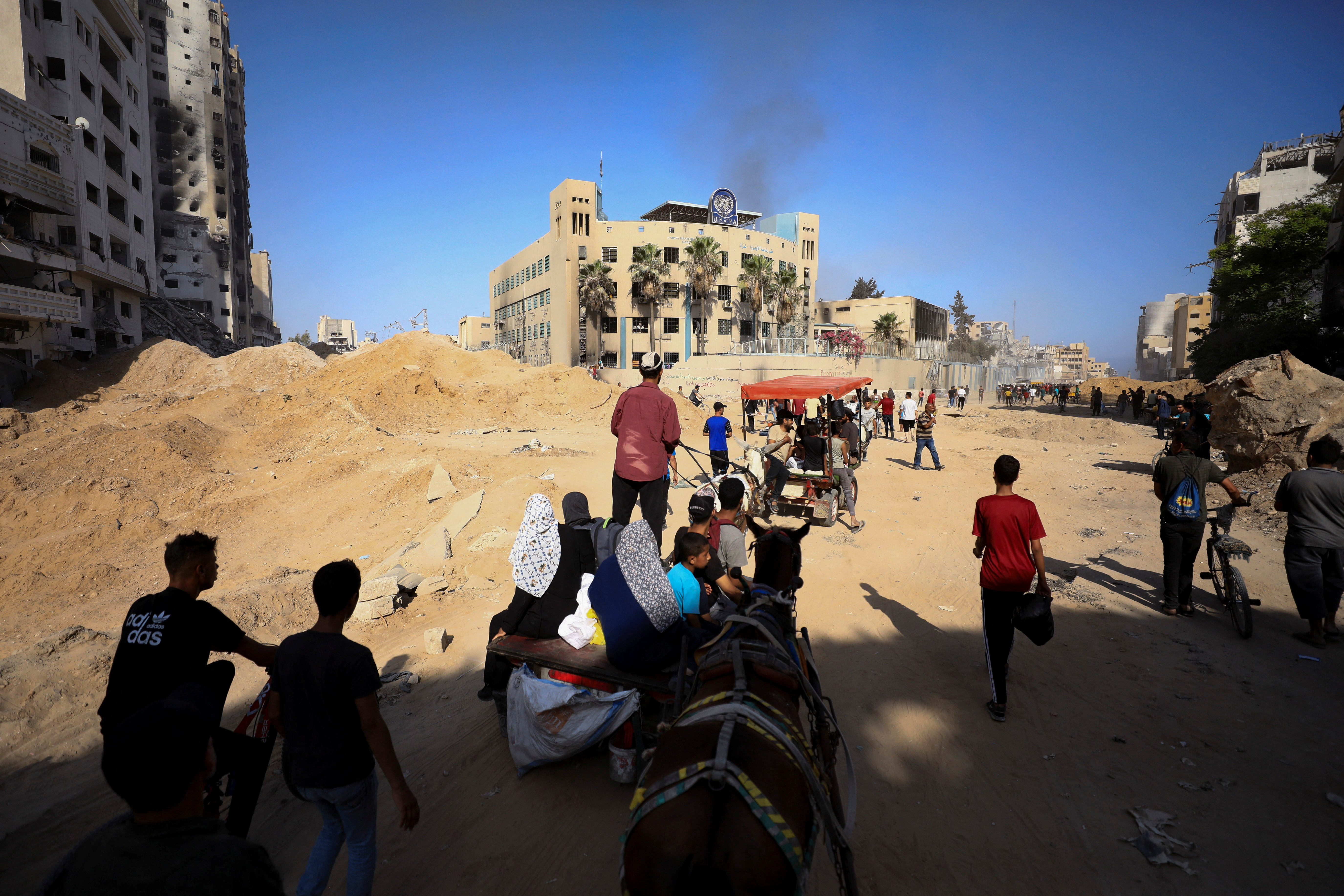 Palestinians gather to inspect the damage at the headquarters of UNRWA, following an Israeli raid in Gaza City. /Dawoud Abu Alkas/Reuters