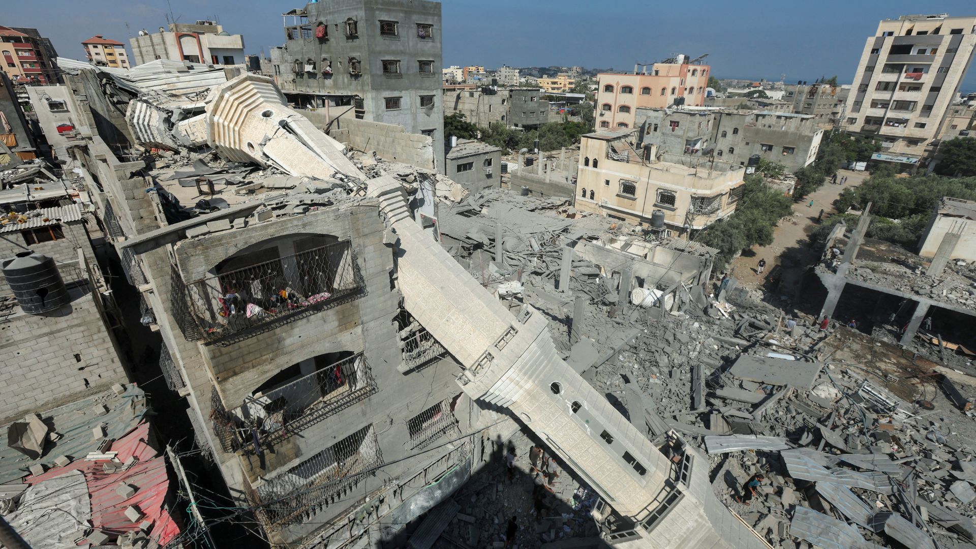 The collapsed minaret of Abdullah Azzam mosque leans against a house after the mosque was hit by an Israeli strike on the Nuseirat refugee camp. /Ramadan Abed/Reuters
