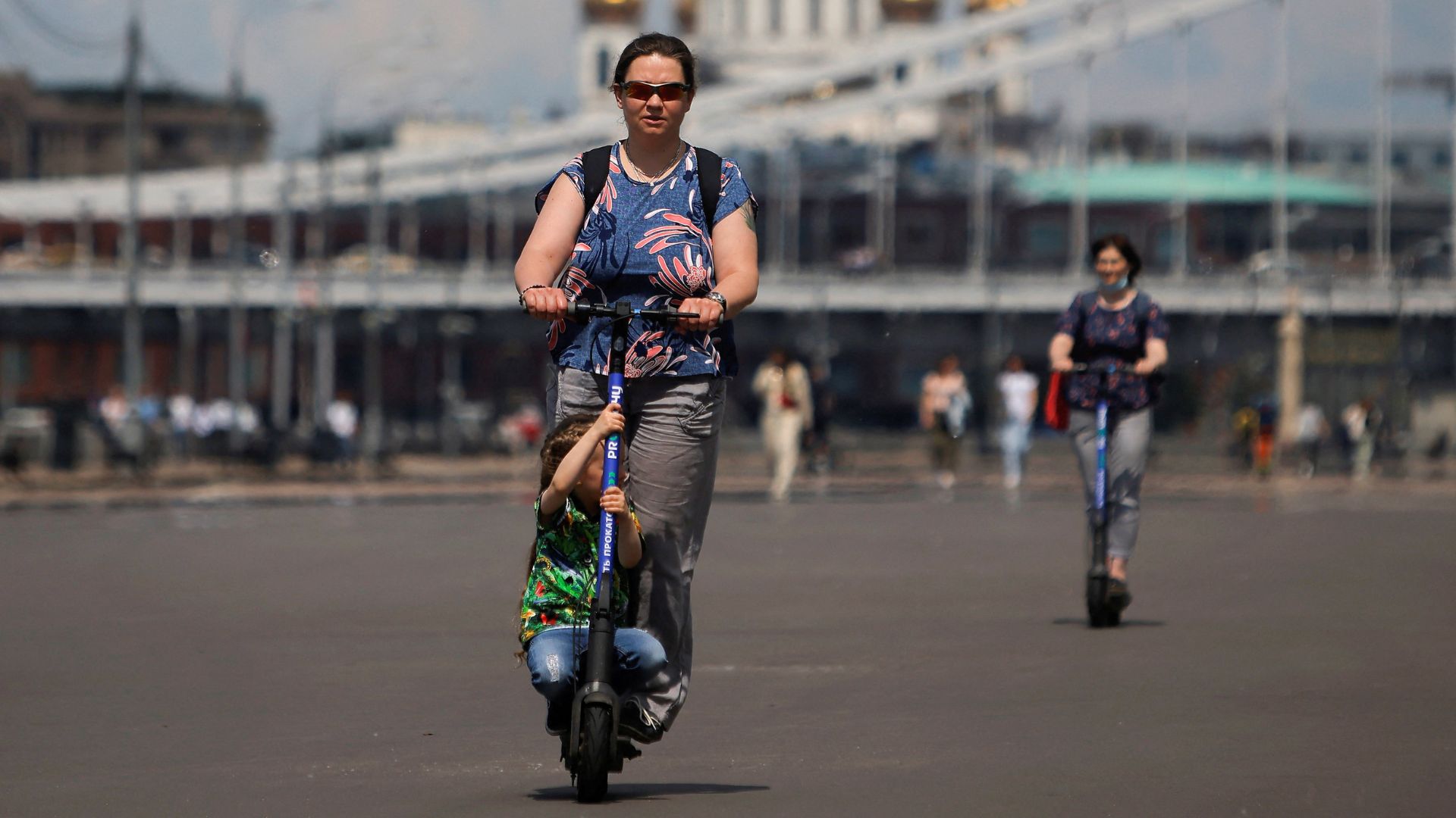 People ride electric scooters in Moscow. /Maxim Shemetov/File/Reuters