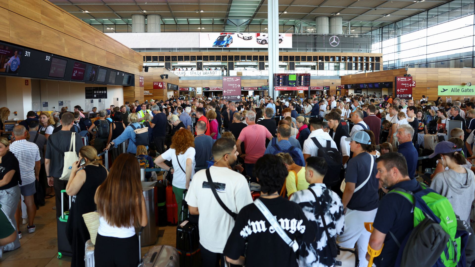 People wait for their flights at Berlin airport following a global IT outage. /Nadja Wohlleben/Reuters