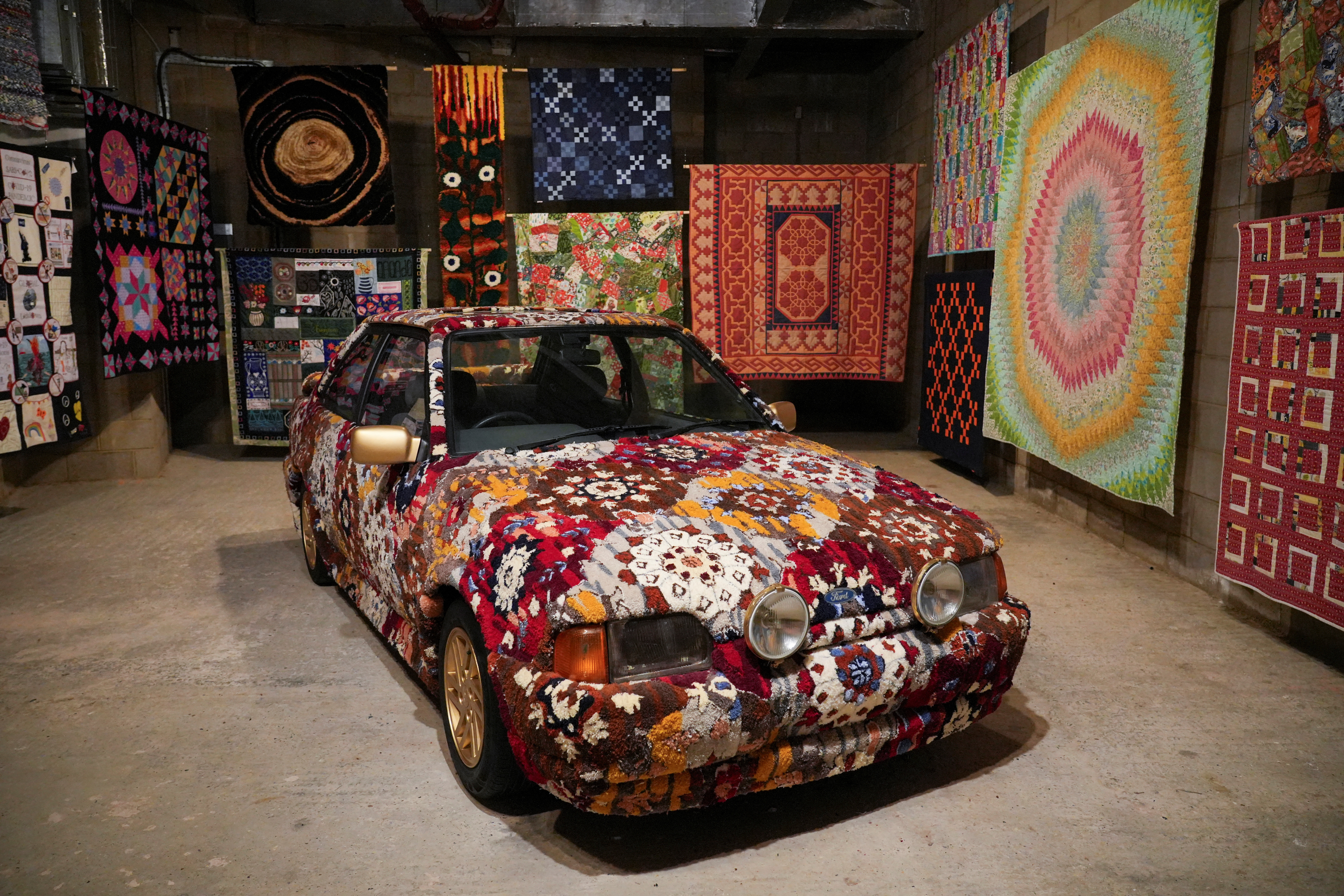 Artist and curator Hetain Patel's artwork titled 'Somerset Road' featuring a Ford Escort tufted by the artist in the pattern of his grandmother's living-room carpet. /Will Russell/Reuters