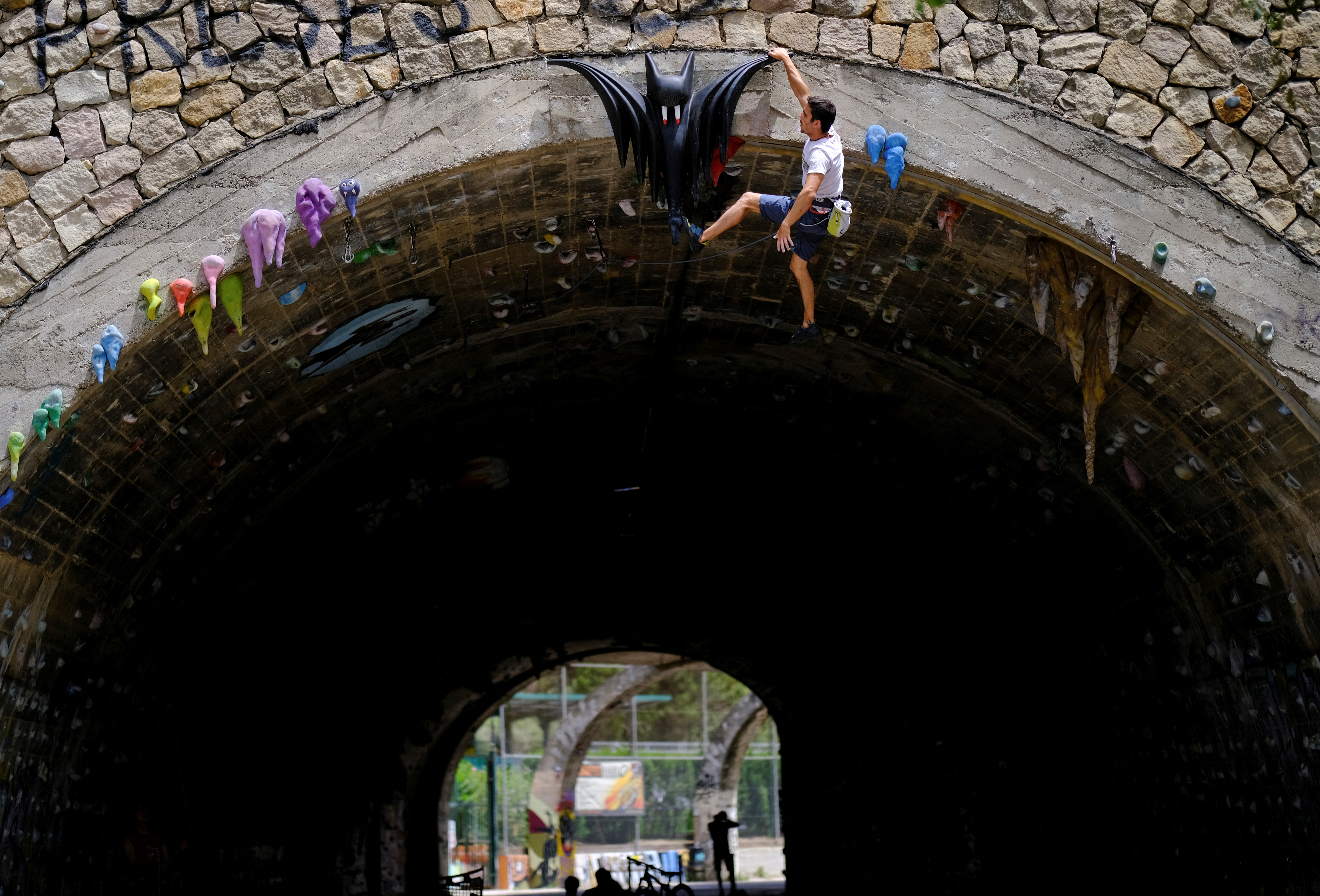 Jose Sanchez Aguilera, 30, climbs the Foixarda tunnel, a former road tunnel transformed into an urban, free-to-use climbing gym. /Nacho Doce/Reuters