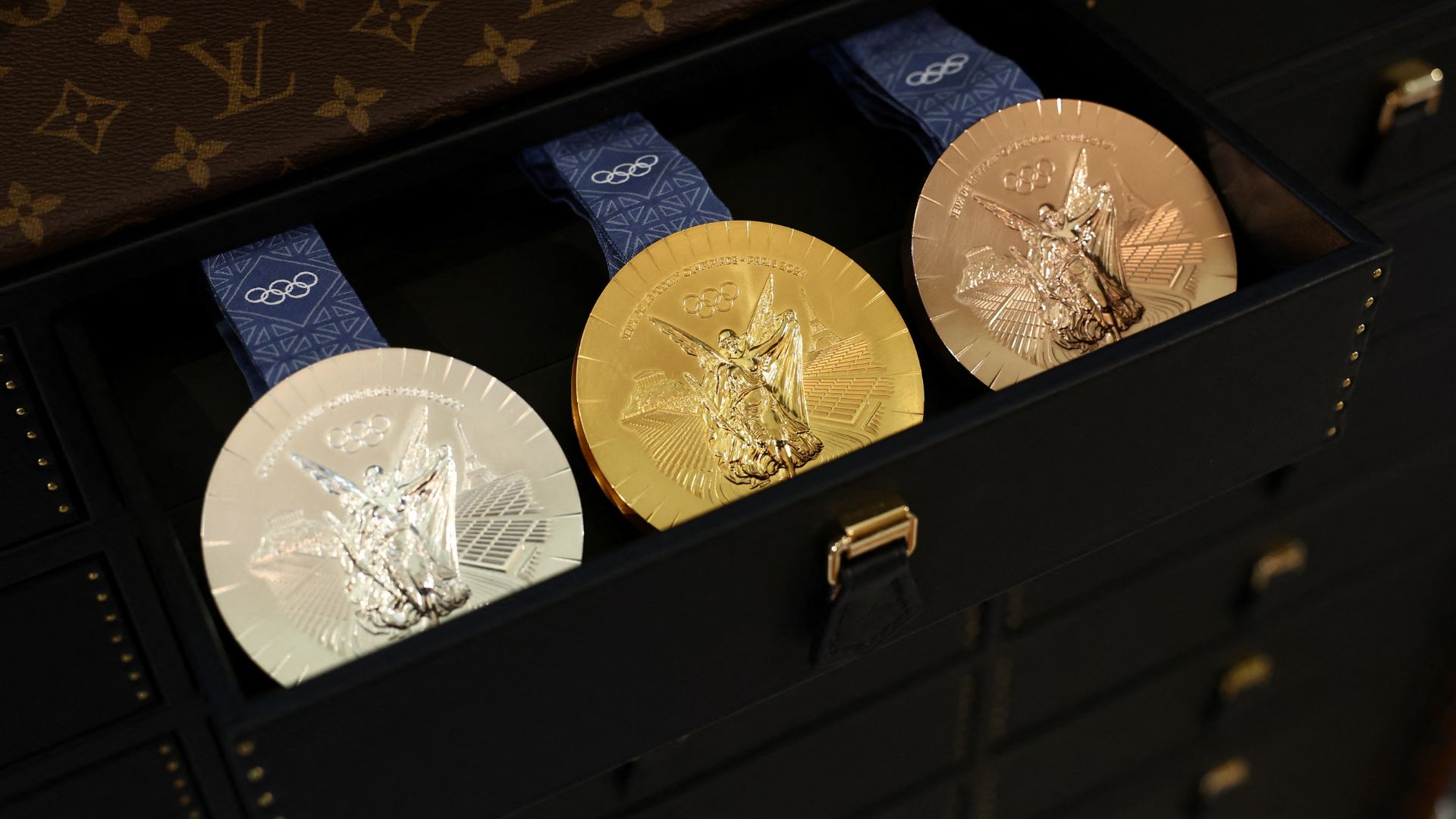 Olympic gold, silver and bronze medals in a Louis Vuitton trunk. /Stephanie Lecocq/Reuters
