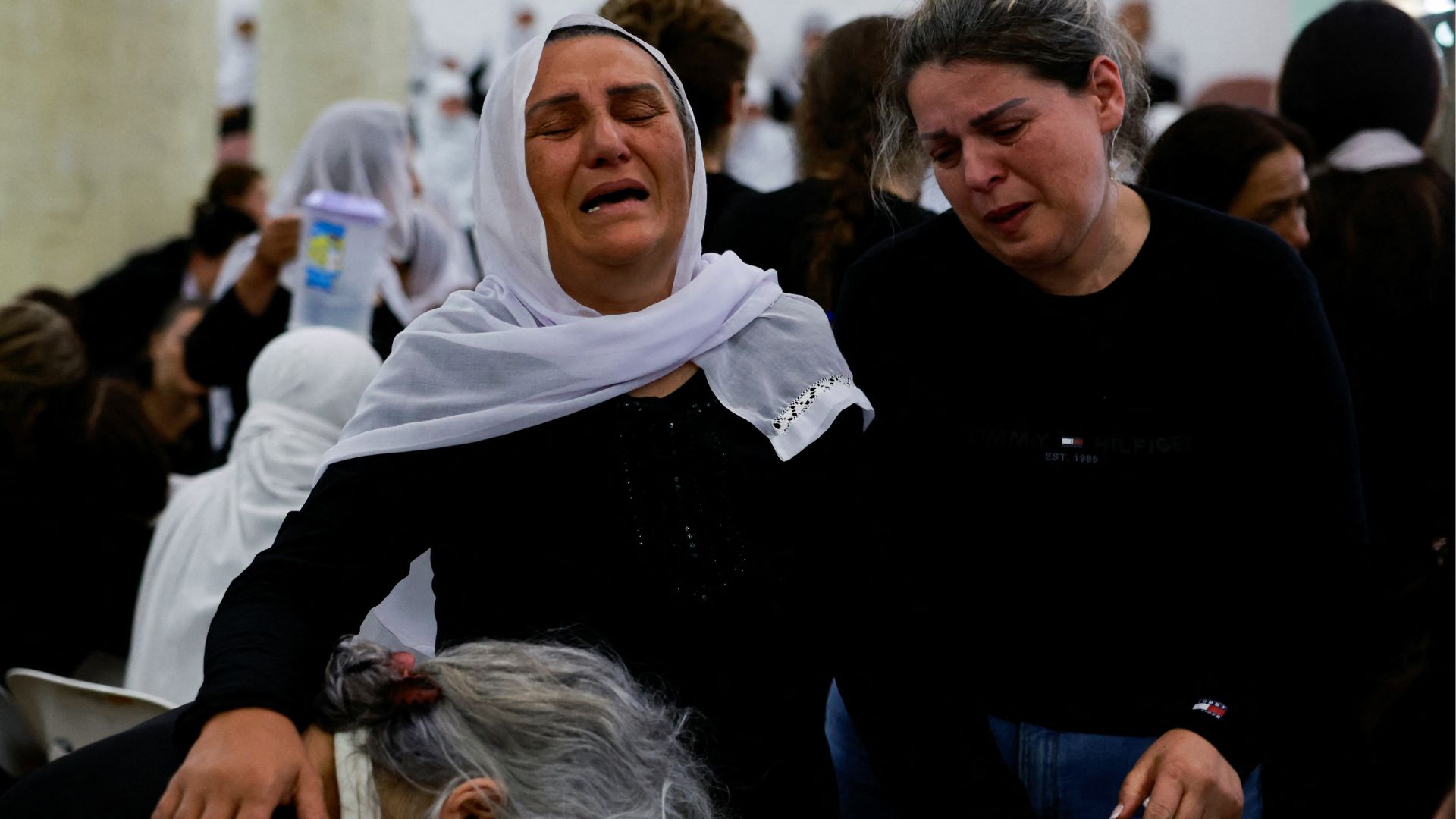 Majdal Shams residents gather for the funerals of 12 children killed during a rocket attack on Saturday. /Ammar Awad/Reuters 