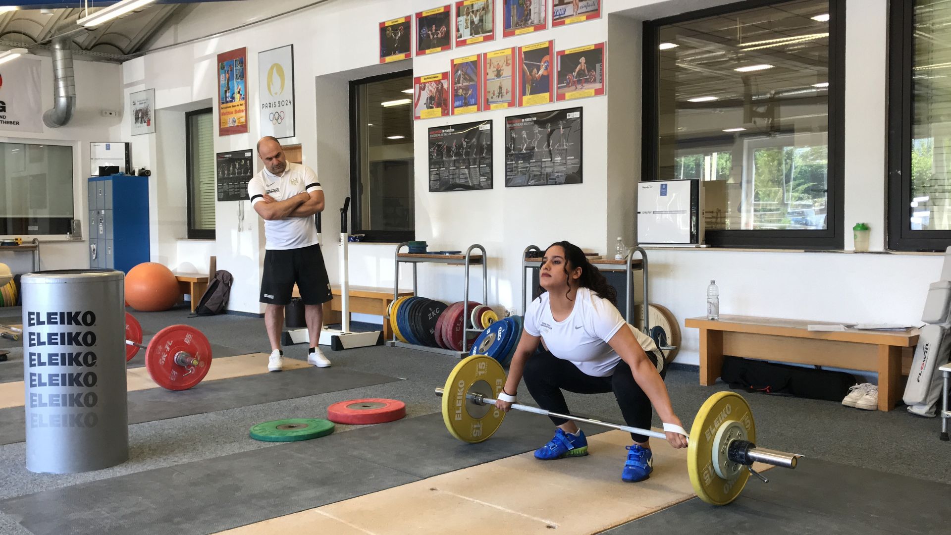 Galeh watched by Germany's national weightlifting coach Almir Velagic. /CGTN