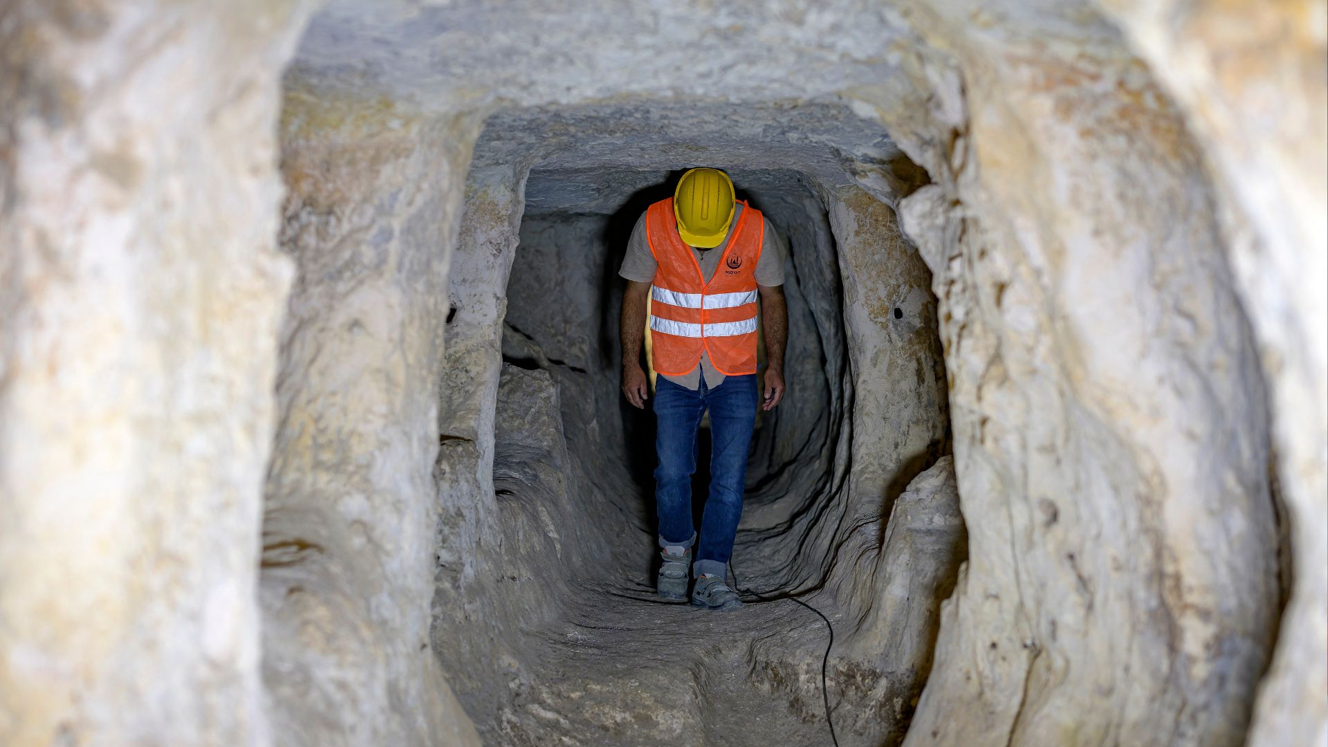 Workers have cleared a small fraction of the 900 square kilometer 'underground city' beneath Midyat in Turkiye. /Yasin Akgul/AFP