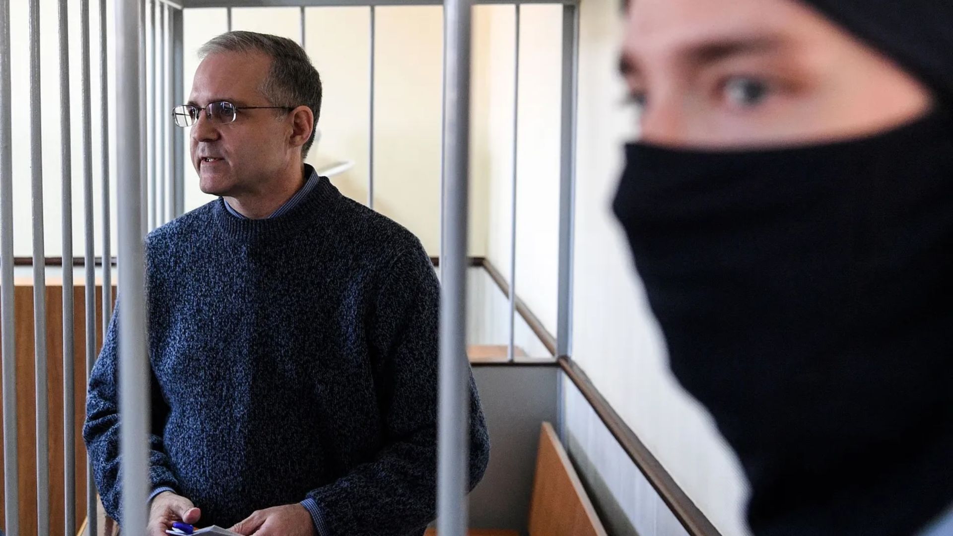 Paul Whelan stands inside a defendant's cage during a hearing at a court in Moscow in 2019. /Kirill Kudryavtsev/AFP