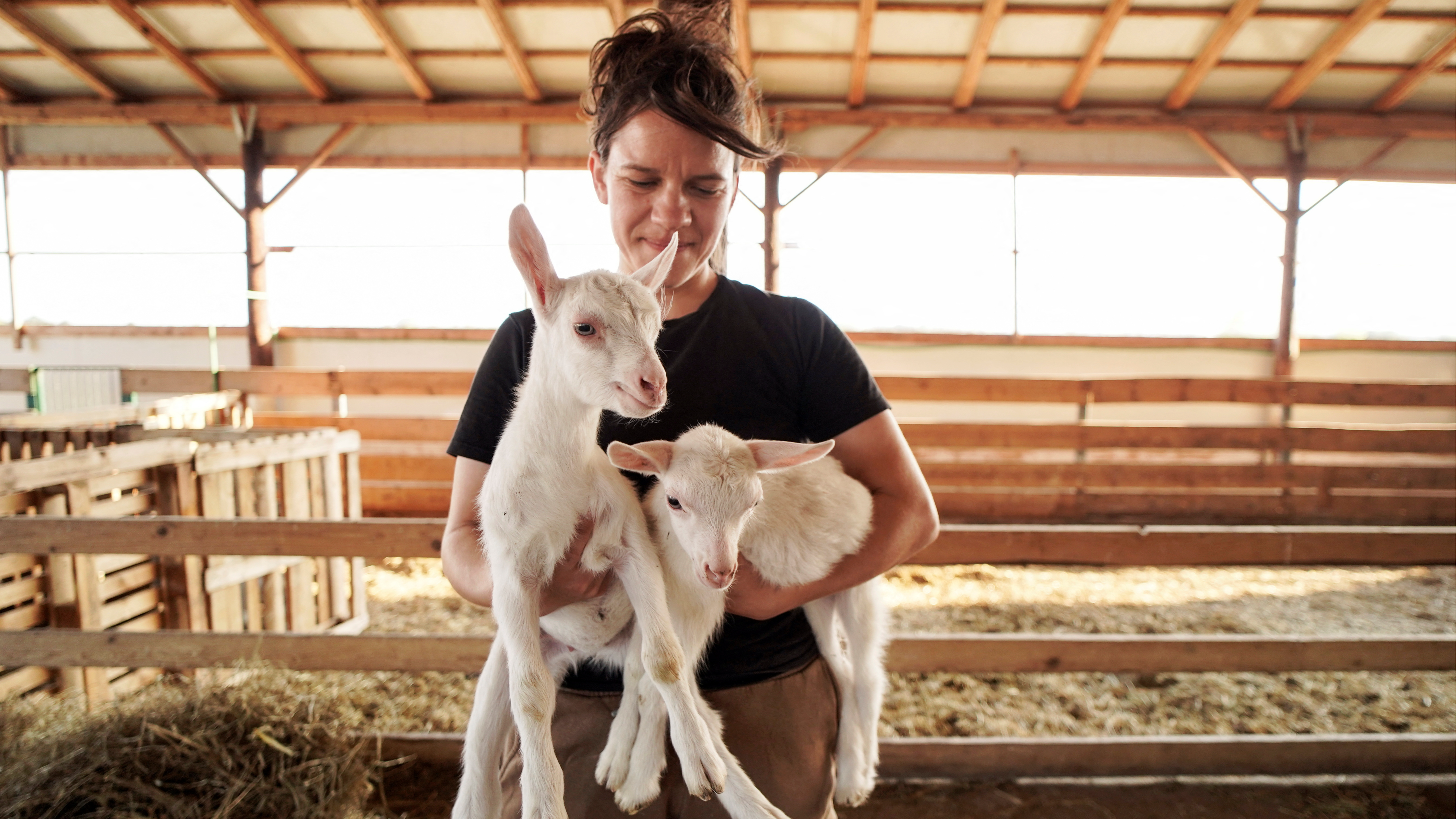 Ioanna Karra with two of her animals at her goat farm in Zilefti in the prefecture of Trikala. /Giannis Floulis/Reuters