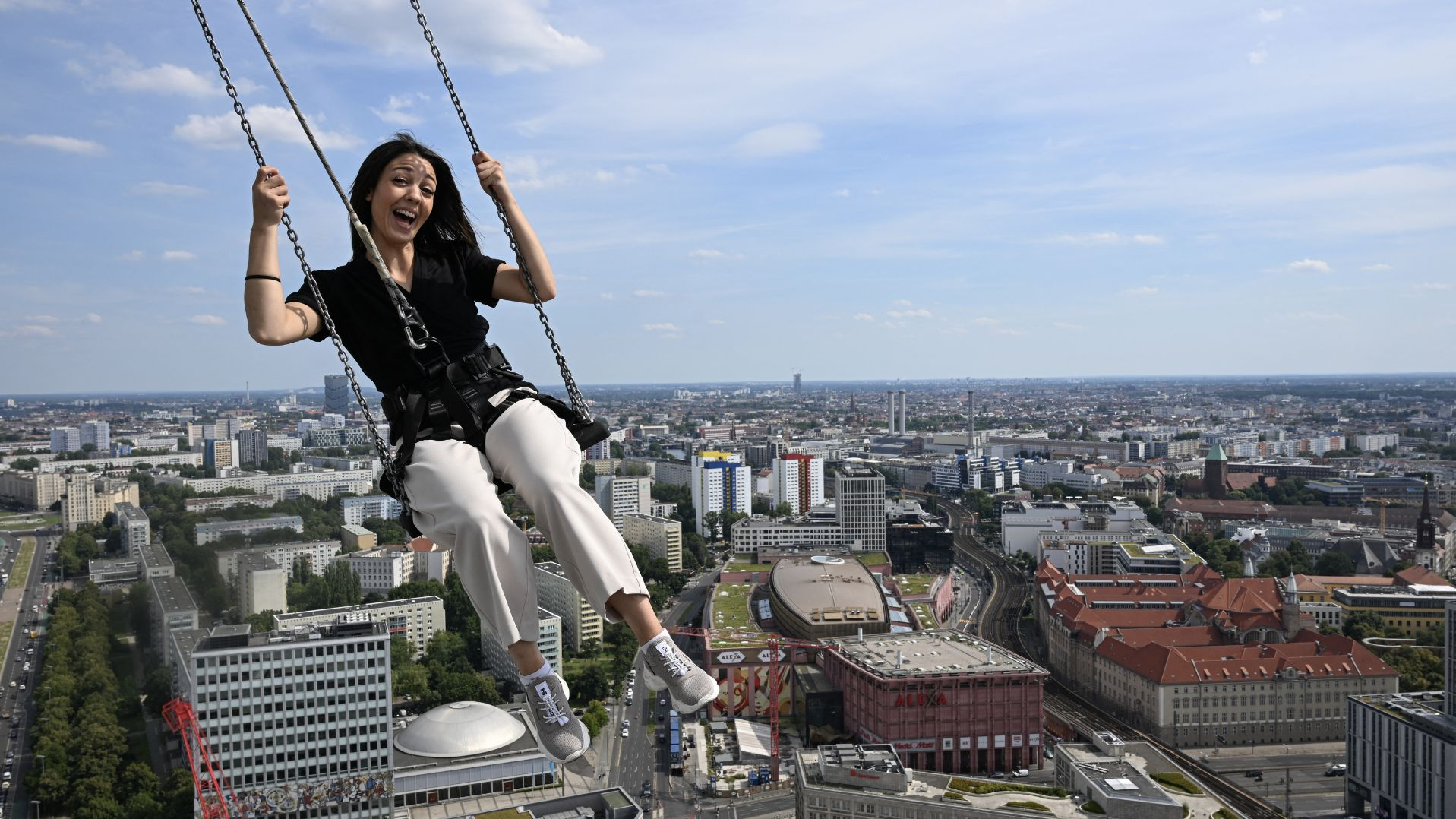 Wendy Sorice swings above the Berlin rooftops. /Ralf Hirschberger/AFP