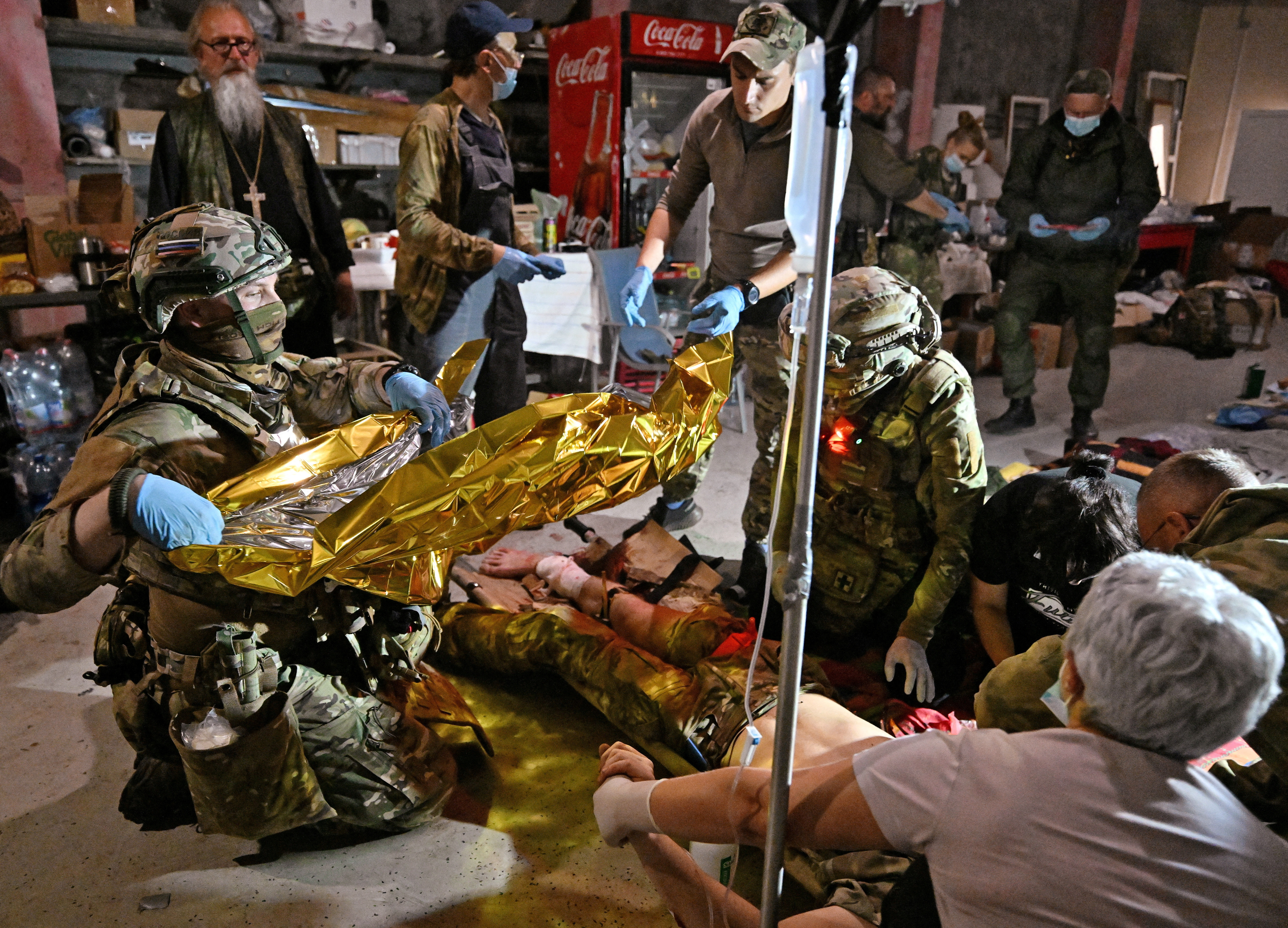 Medics deliver medical aid at a mobile medical station opened by volunteers to treat wounded Russian military personnel in the Kursk region. /Anatoliy Zhdanov/Reuters