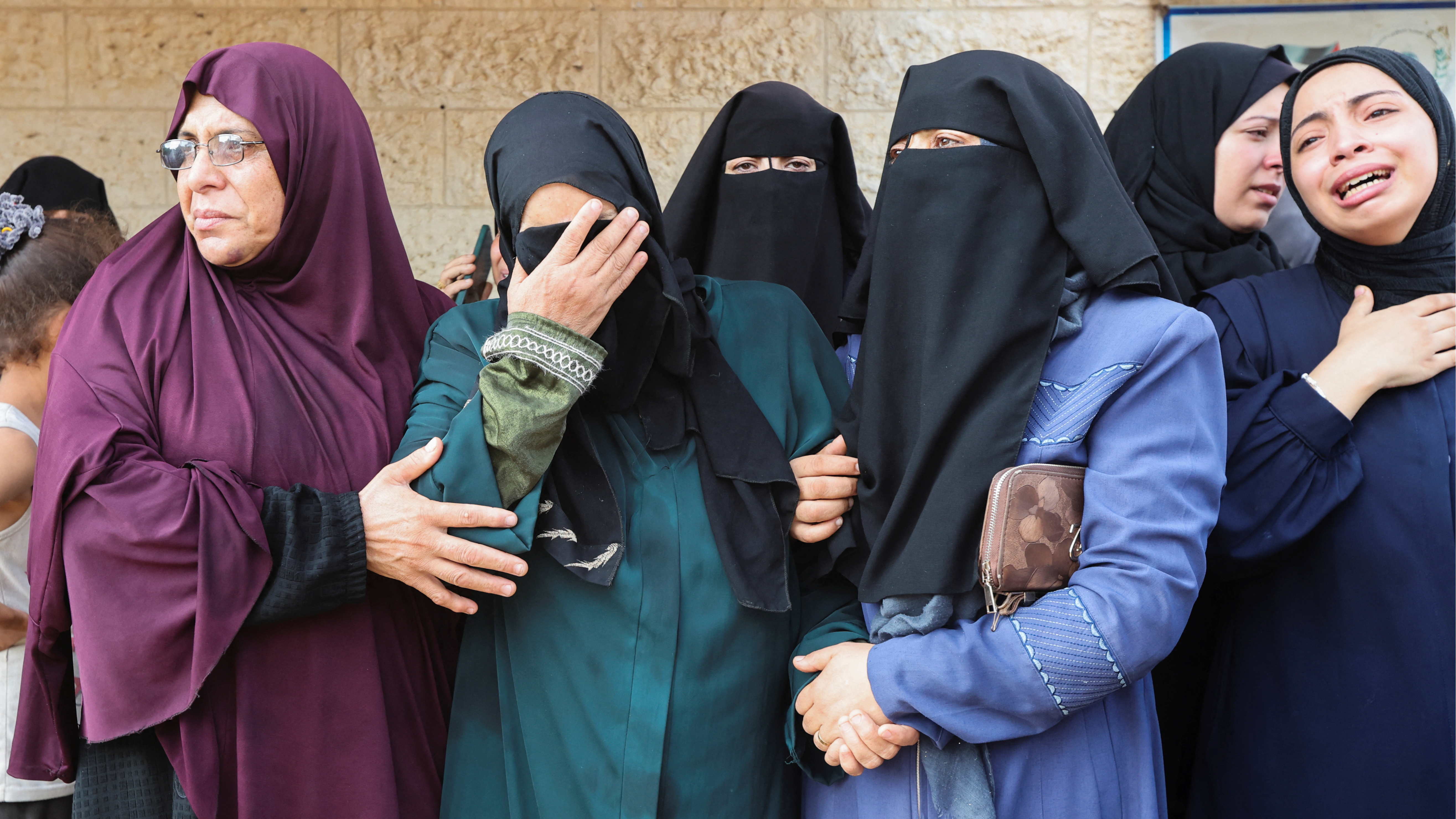 Palestinian women mourn, at Al-Aqsa Martyrs Hospital in Deir Al-Balah in the central Gaza Strip, for the Palestinians killed in Israeli strikes. /Ramadan Abed/Reuters