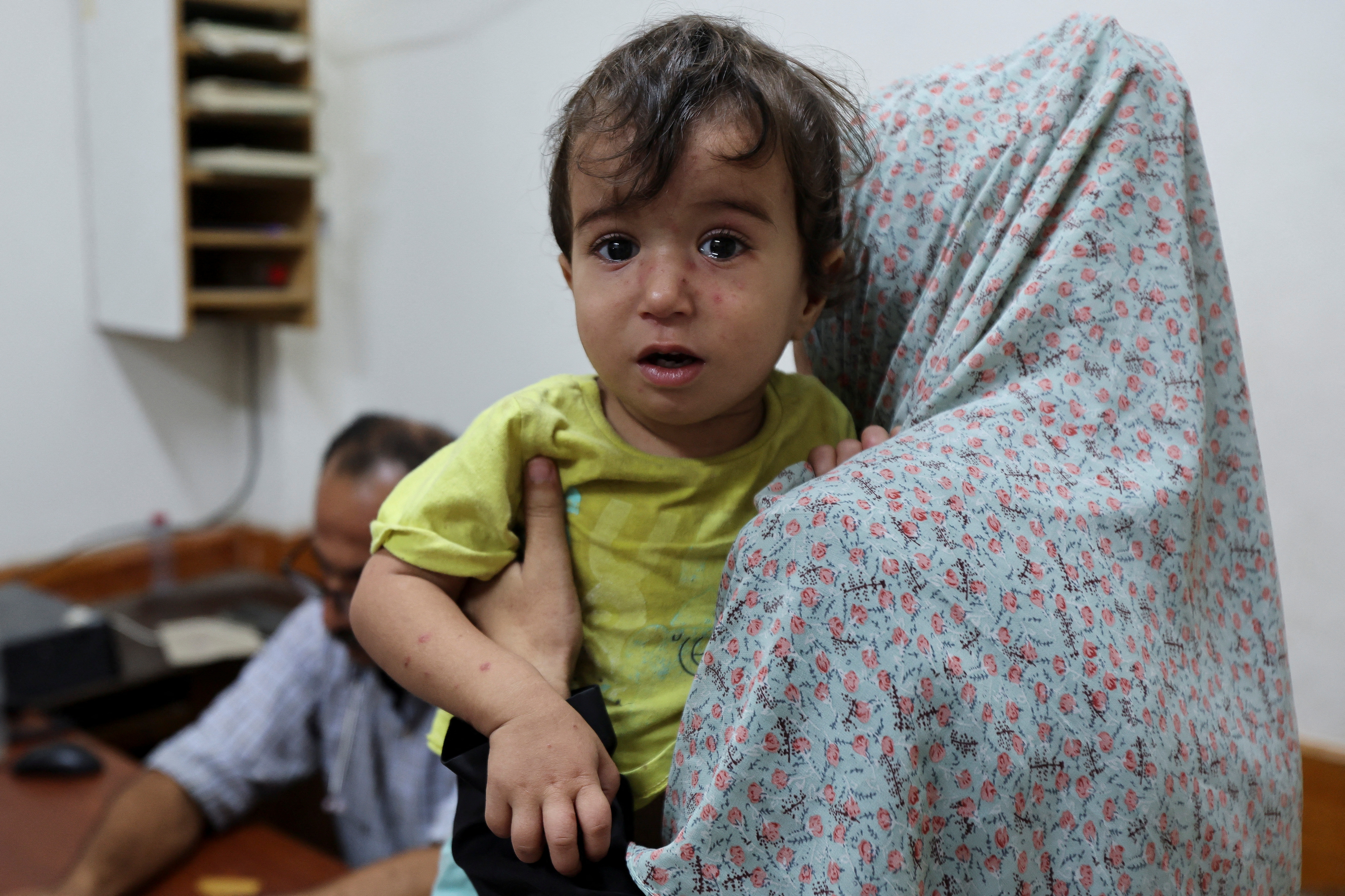 A Palestinian child looks on while being examined by a doctor at Al-Aqsa Martyrs Hospital, amid fears over the spread of polio. /Ramadan Abed/Reuters