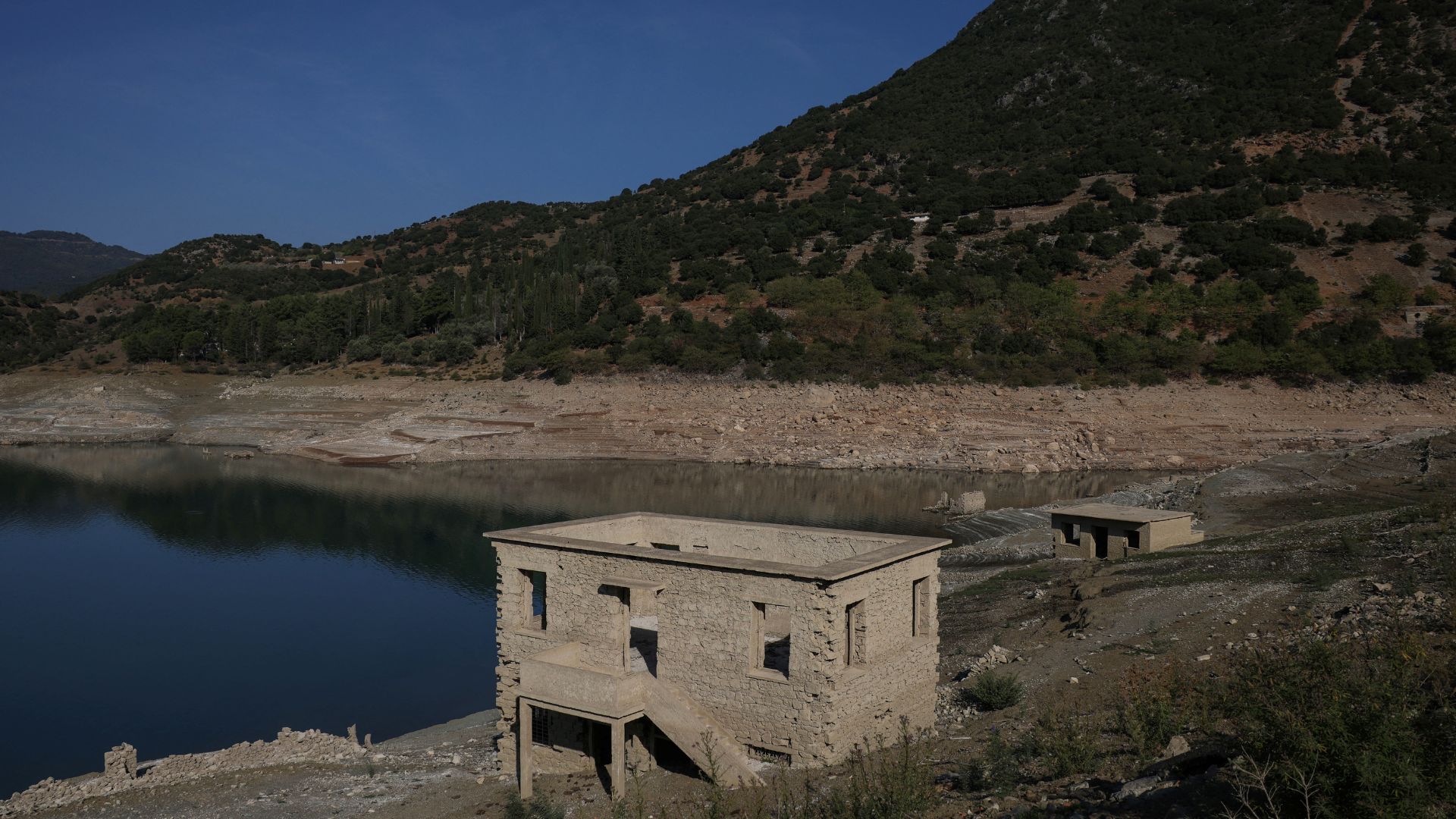 The buildings of Kallio, a village intentionally flooded in 1980 to create a reservoir for nearly half the Greek population, are rising again as drought drops the water levels. /Stelios Misinas/Reuters