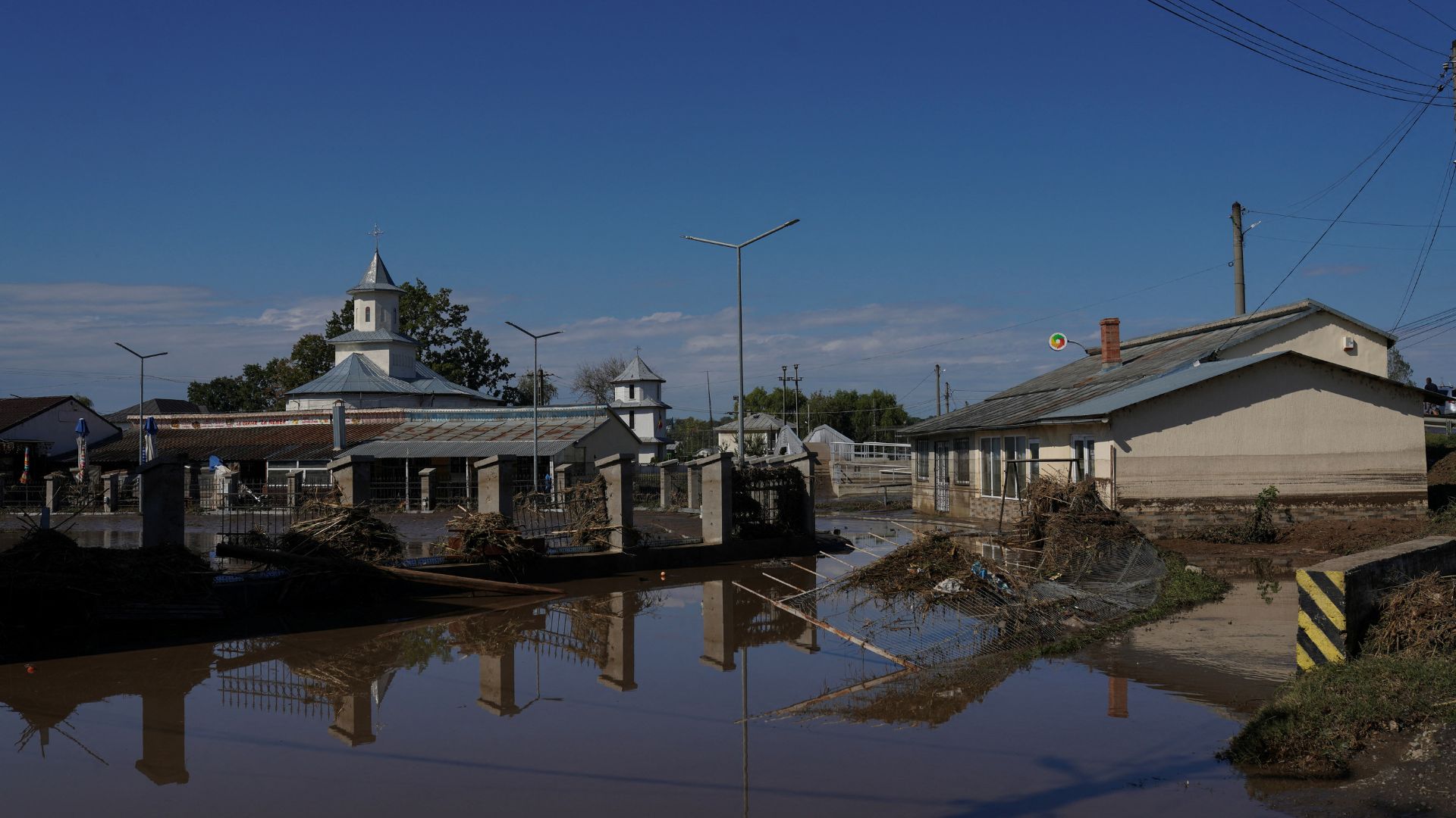 Blue skies reflect in floodwater in Pechea, Galati county, Romania. /Andreea Campeanu/Reuters