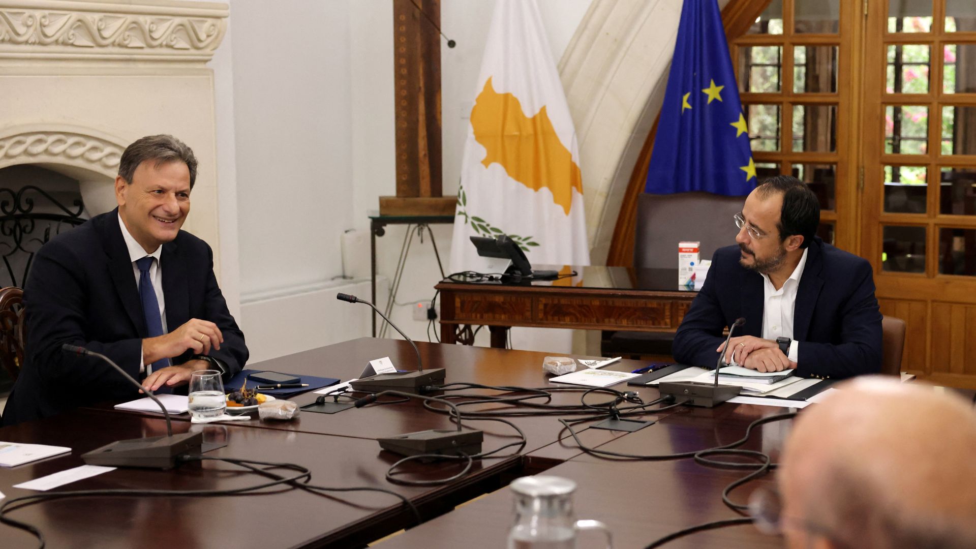 Cyprus President Nikos Christodoulides and Greek Energy Minister Theodoros Skylakakis talk during a meeting to discuss the modalities of the subsea cable. /Reuters/Yiannis Kourtoglou
