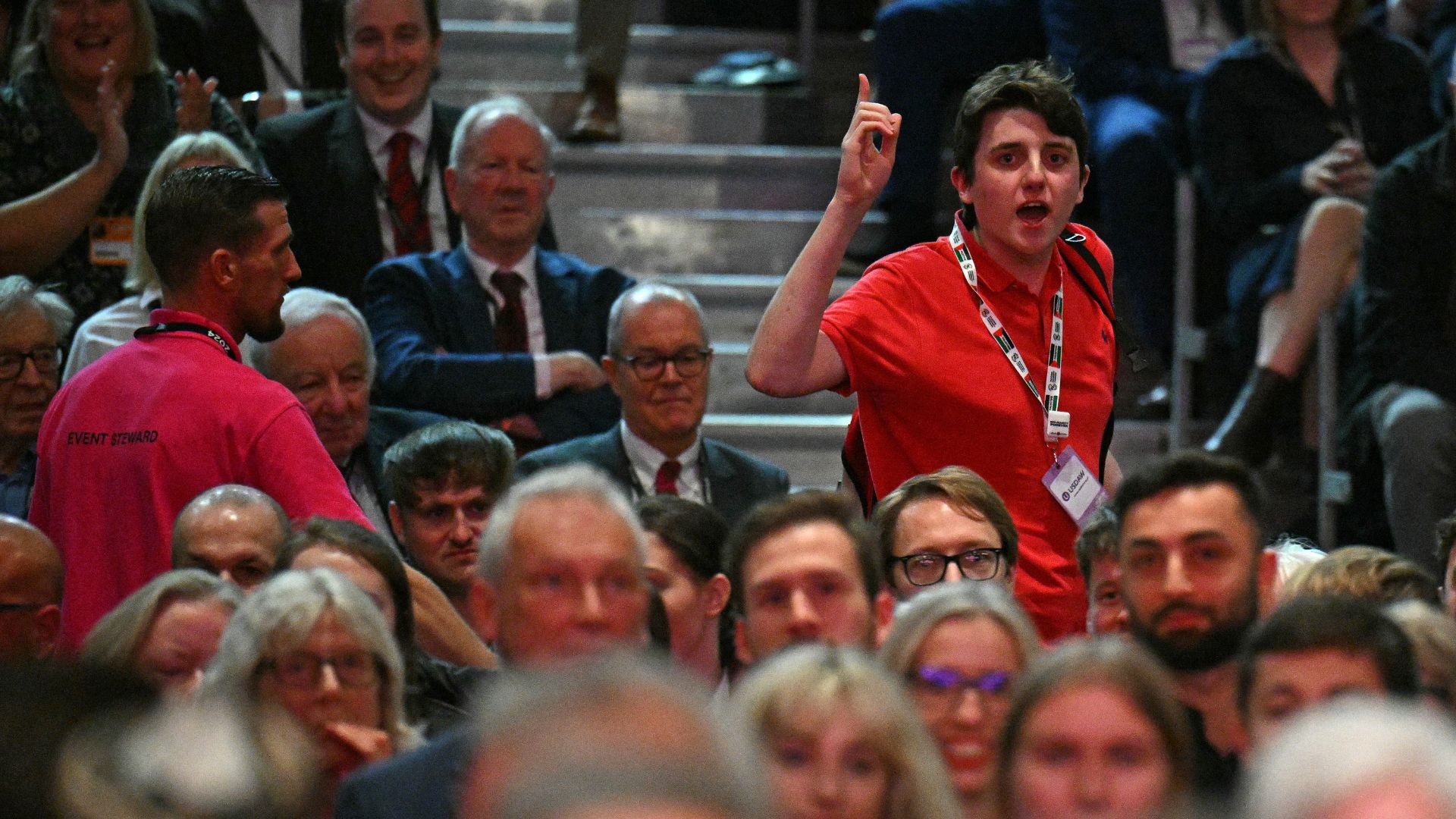 A heckler is escorted out of the auditorium during Starmer's keynote speech. /Oli Scarff/AFP
