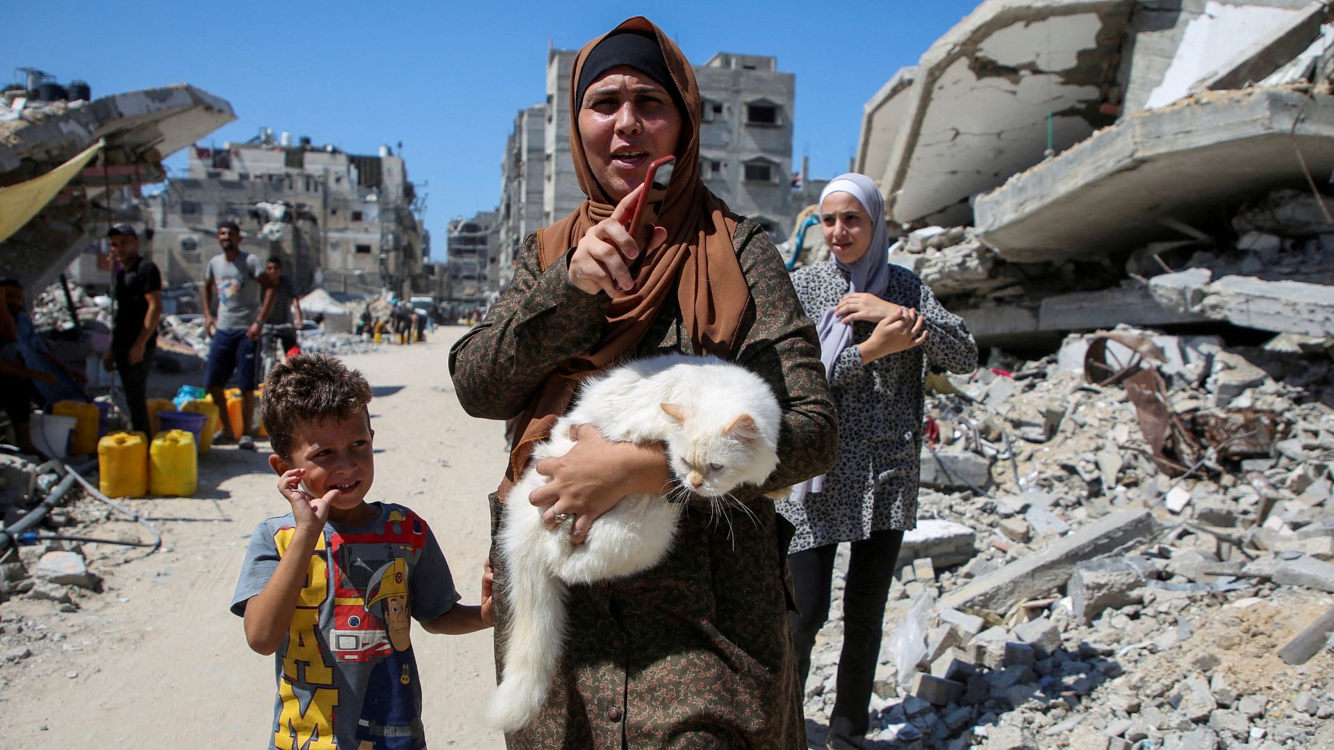 A Palestinian woman amongst the rubble destroyed in Israel's offensive in Khan Younis in the Gaza Strip. /Hatem Khaled/Reuters