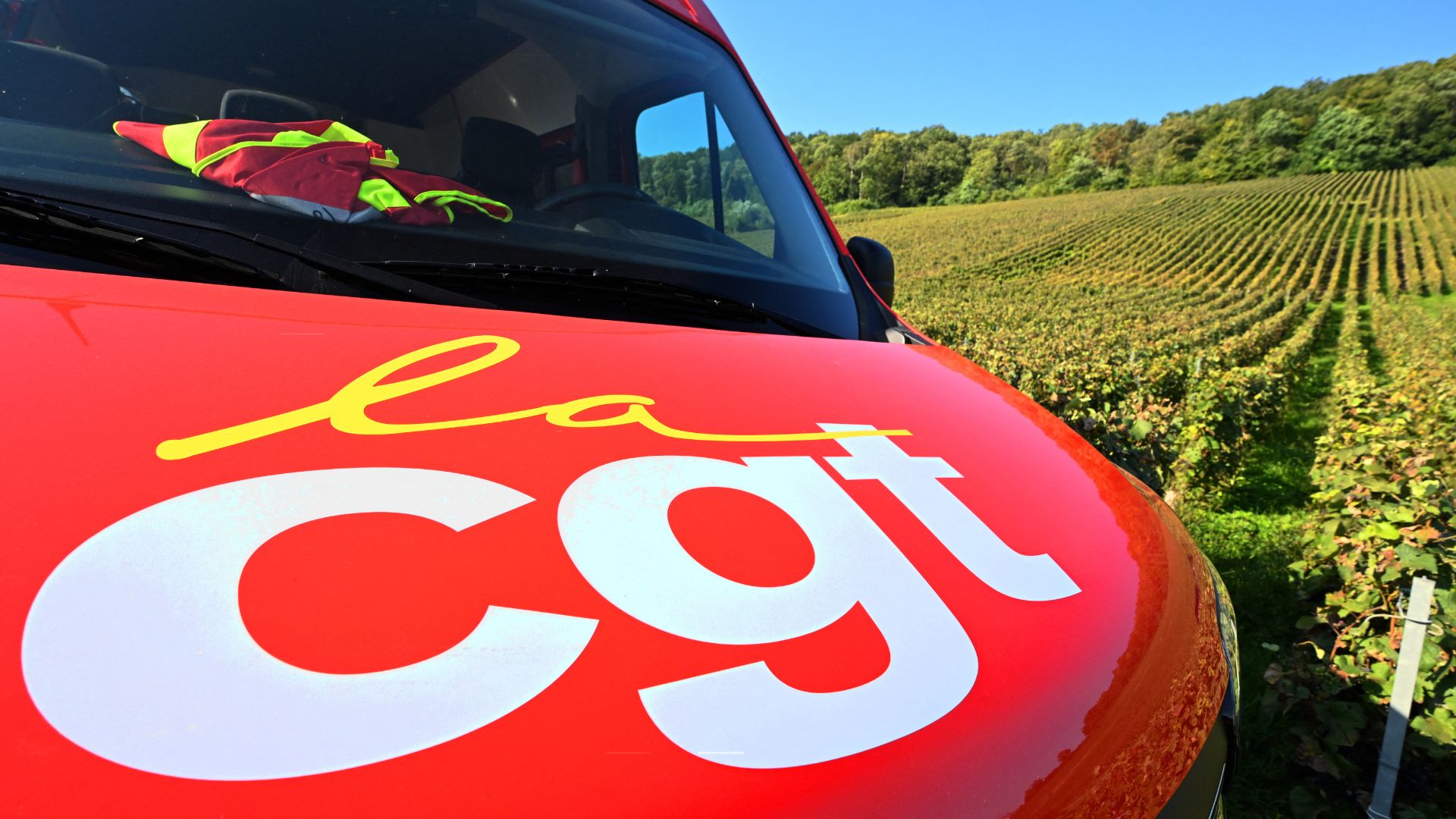 A French General Confederation of Labor (CGT) union van sits parked near a Champagne vineyard as union representatives distribute pamphlets to seasonal workers. /Francois Nascimbeni/AFP