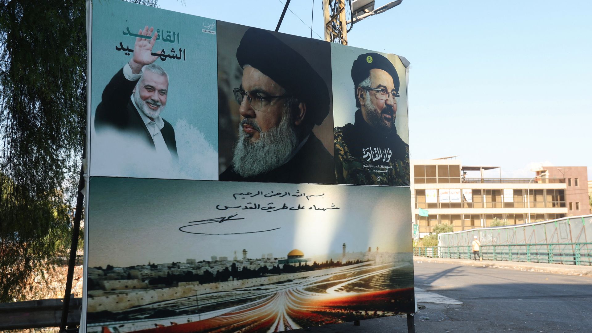 A poster in Lebanon depicting late Hamas leader Ismail Haniyeh, Hezbollah leader Sayyed Hassan Nasrallah and Hezbollah top commander Fuad Shukr. /Azia Taher/Reuters