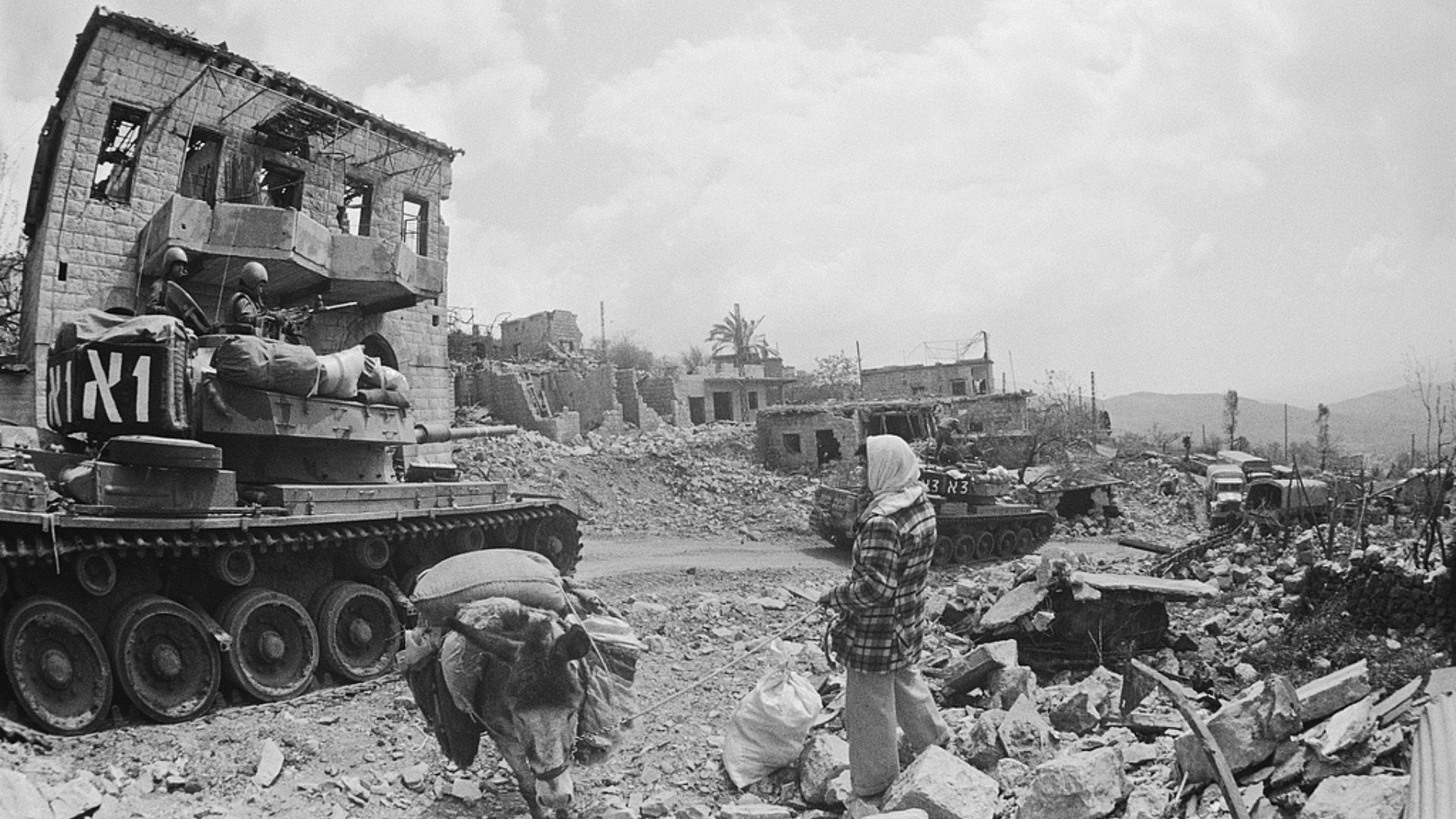 Residents watch as Israeli forces roll through the village of Rachie El in southern Lebanon on March 19, 1978. /William Karel/Sygma/Getty Images via CFP