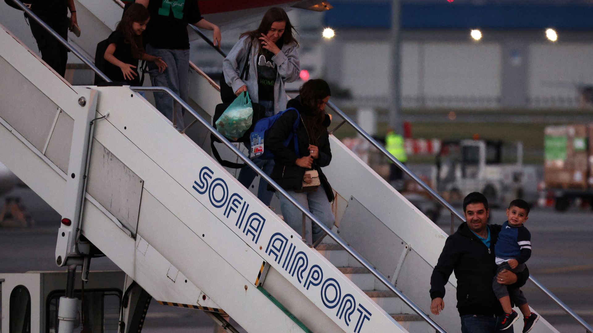 People disembark from a Bulgarian government plane following its arrival from an evacuation flight from Lebanon, at Sofia airport on Monday. /Stoyan Nenov/Reuters
