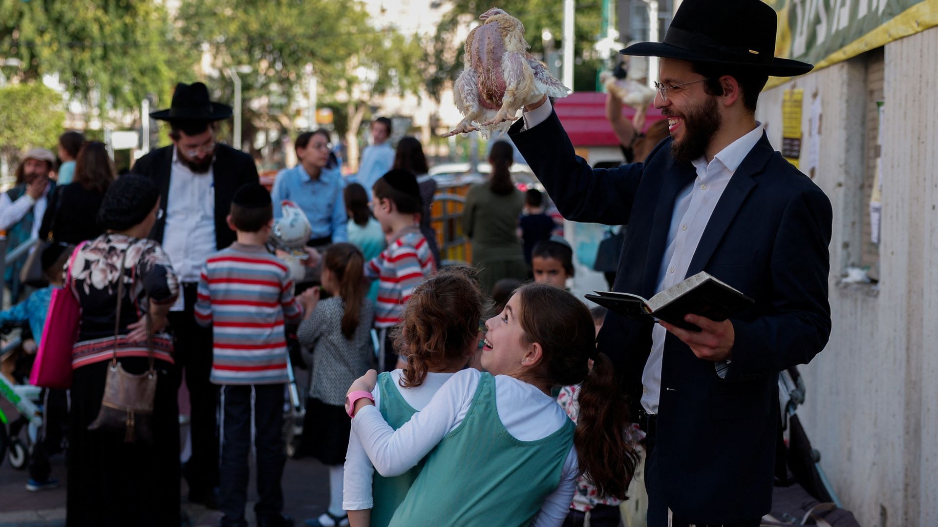 Ultra-Orthodox Jewish people perform the Kaparot ritual, where white chickens are slaughtered as a symbolic gesture of atonement, ahead of Yom Kippur. /Gonzalo Fuentes/Reuters