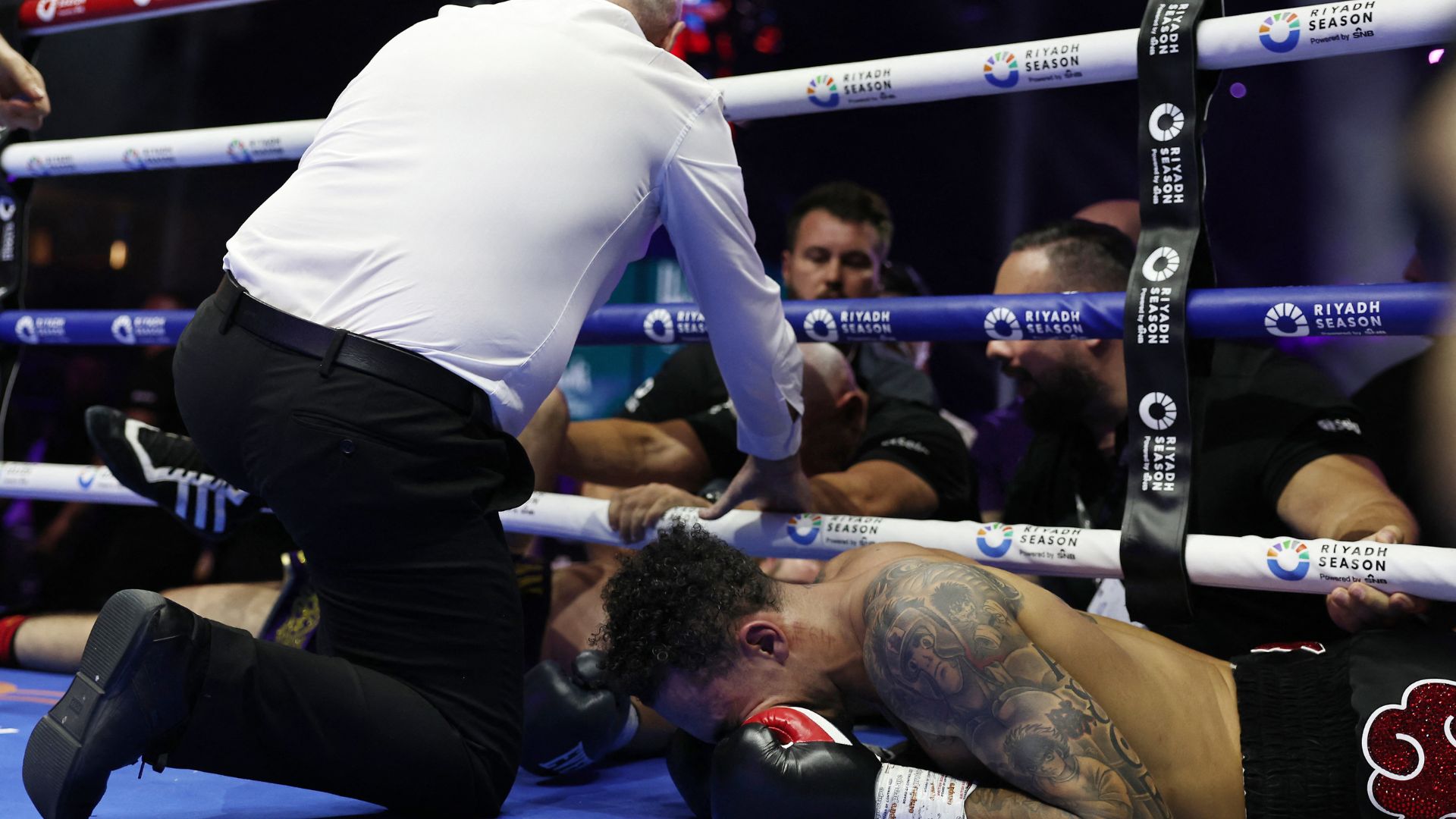 Whittaker holds his face while his contest against Cameron is declared a draw. /Hamad I Mohammed/Reuters