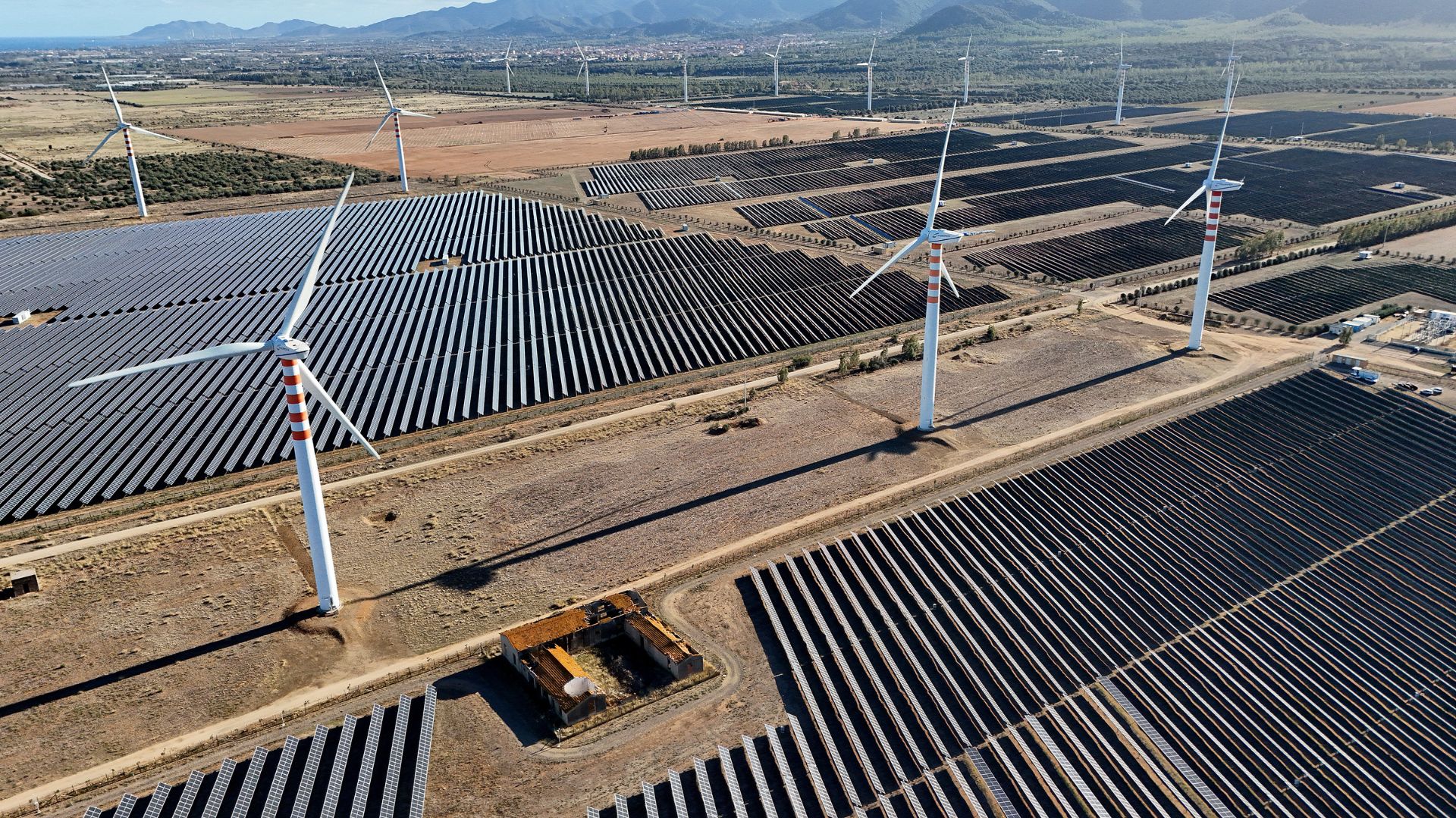 Wind turbines and solar panels on a campus near Cagliari. Sardinia currently relies largely on coal. /Giovanni Grezzi/AFP