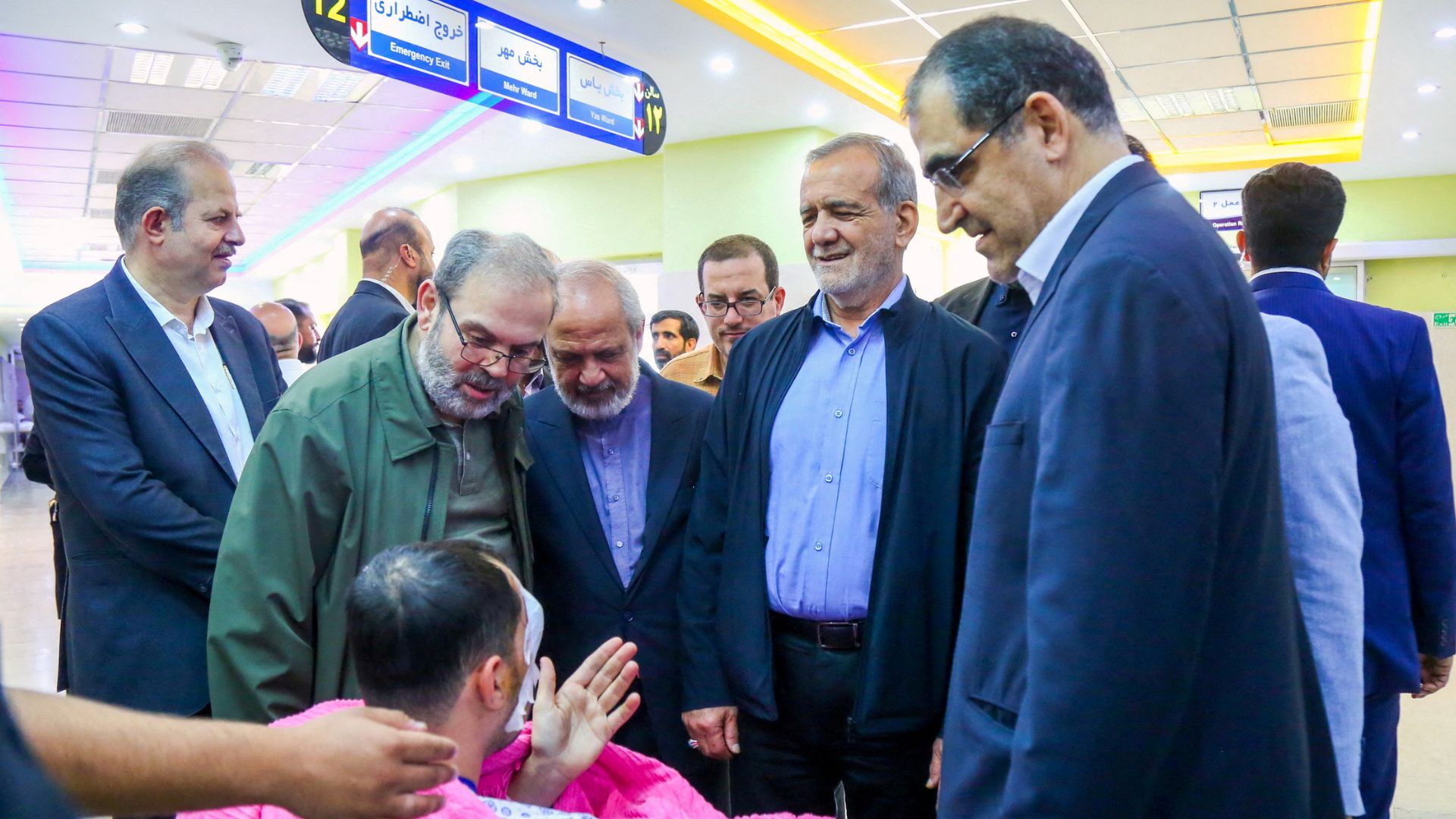 Iran's President Masoud Pezeshkian visits one of the victims injured by pager explosions. /Iran's Presidency/WANA