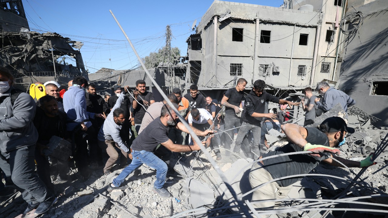 Rescuers search for survivors under the rubble a day after an Israeli airstrike in Beirut's southern suburb of Jnah. /Ibrahim Amro/AFP