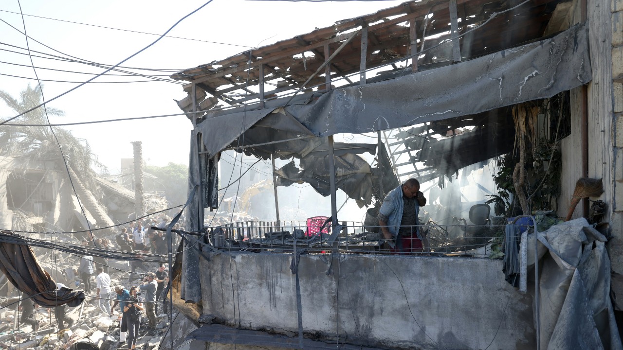 A man inspects the debris a day after an Israeli airstrike in Beirut's southern suburb of Jnah, amid the ongoing war between Israel and Hezbollah. /Ibrahim Amro/AFP