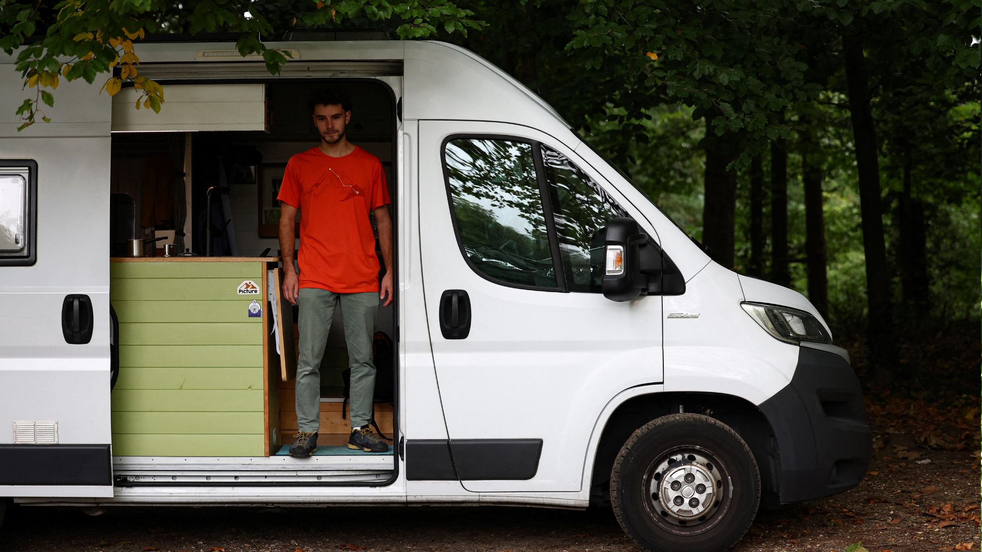 Leduc poses in his van in the forest of Meudon, before climbing the Franklin Tower. /Anne-Christine Poujoulat/AFP
