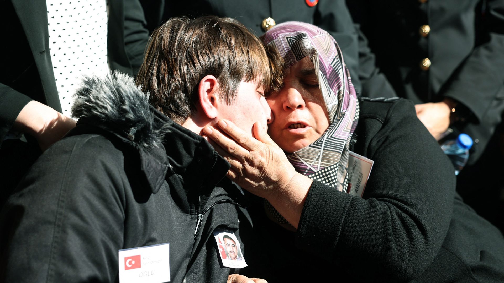 Family members of killed taxi driver Murat Arslan comfort each other during his funeral, the day after he was killed in a bomb attack to the state-run Turkish Aerospace Industries building. /Adem Altan/AFP