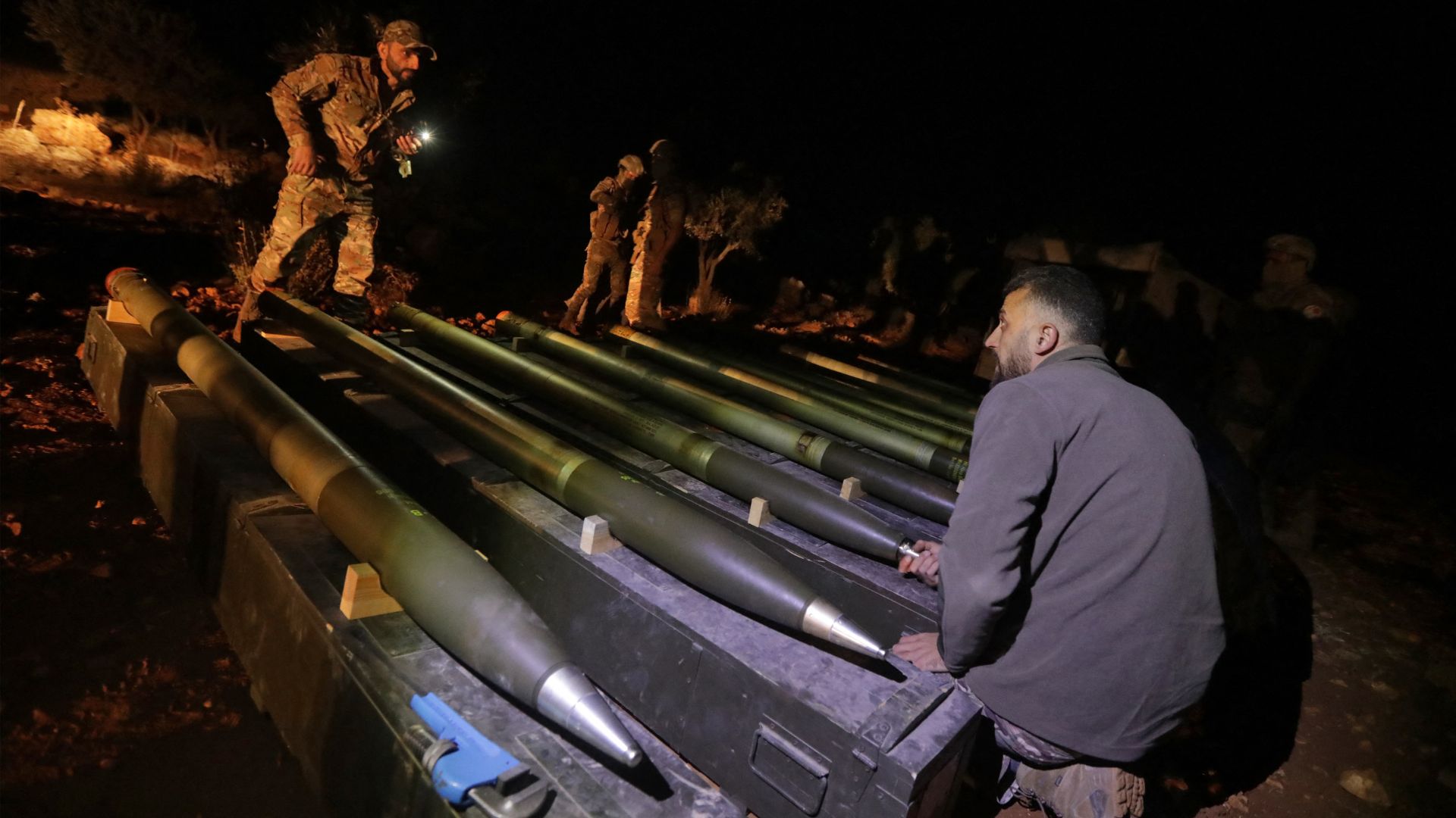 Turkish-backed Syrian fighters prepare rockets to be fired towards areas in north-eastern Syria controlled by the Kurdish-led Syrian Democratic Forces (SDF). /Bakr Alkasem/AFP