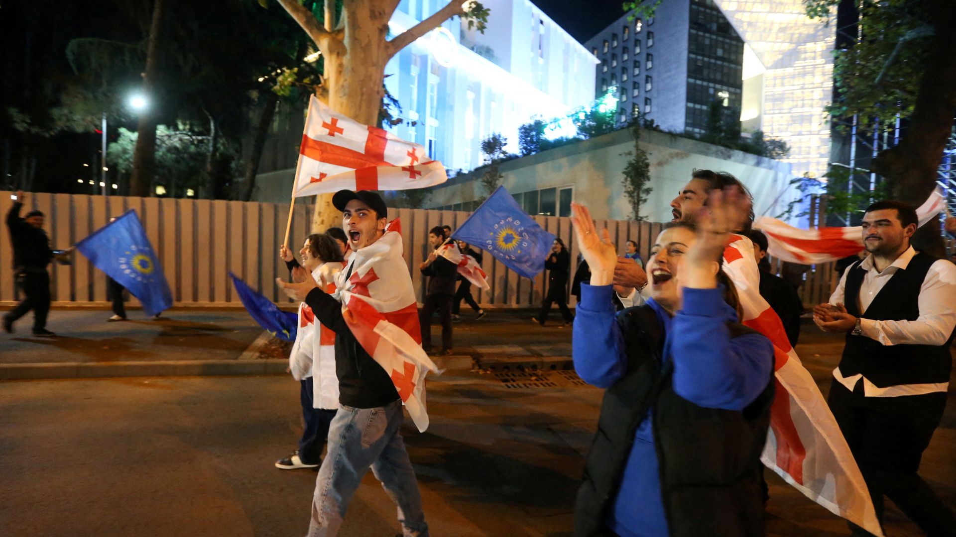 Georgian Dream party supporters in Tbilisi celebrate in the street after the announcement of exit poll results in parliamentary elections. /Irakli Gedenidze/Reuters