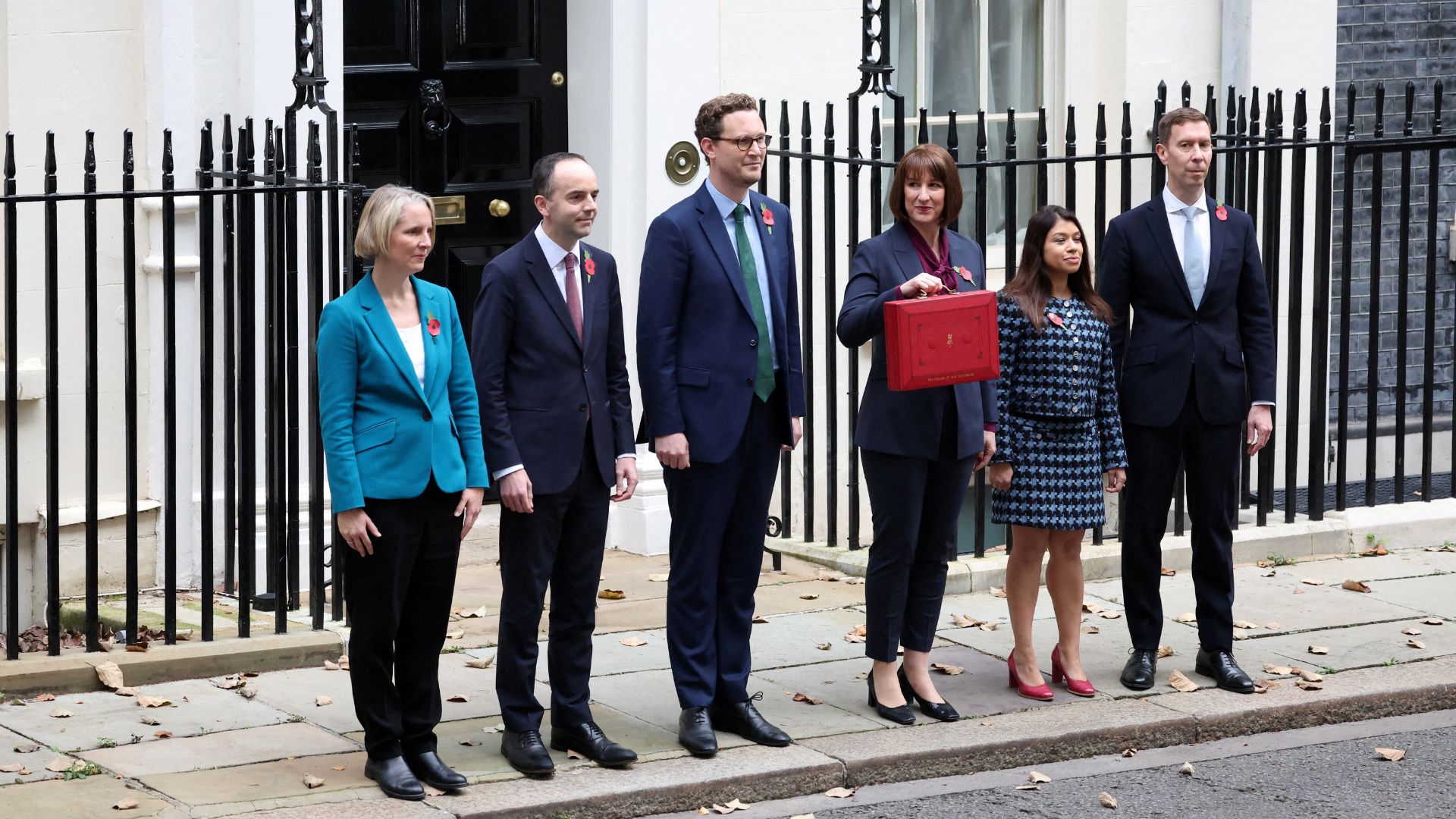 Britain's Chancellor of the Exchequer Rachel Reeves poses with the red budget box outside her office on Downing Street with her parliamentary team. /Suzanne Plunkett/Reuters
