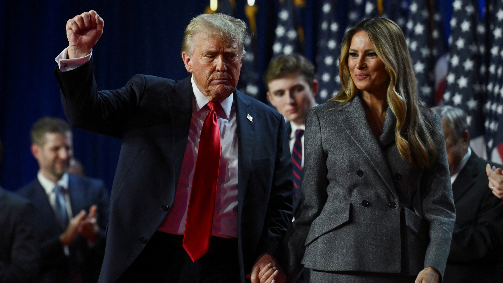 Trump holds up a fist as he takes the stage with his wife Melania and son Barron. /Reuters/Callaghan O'Hare