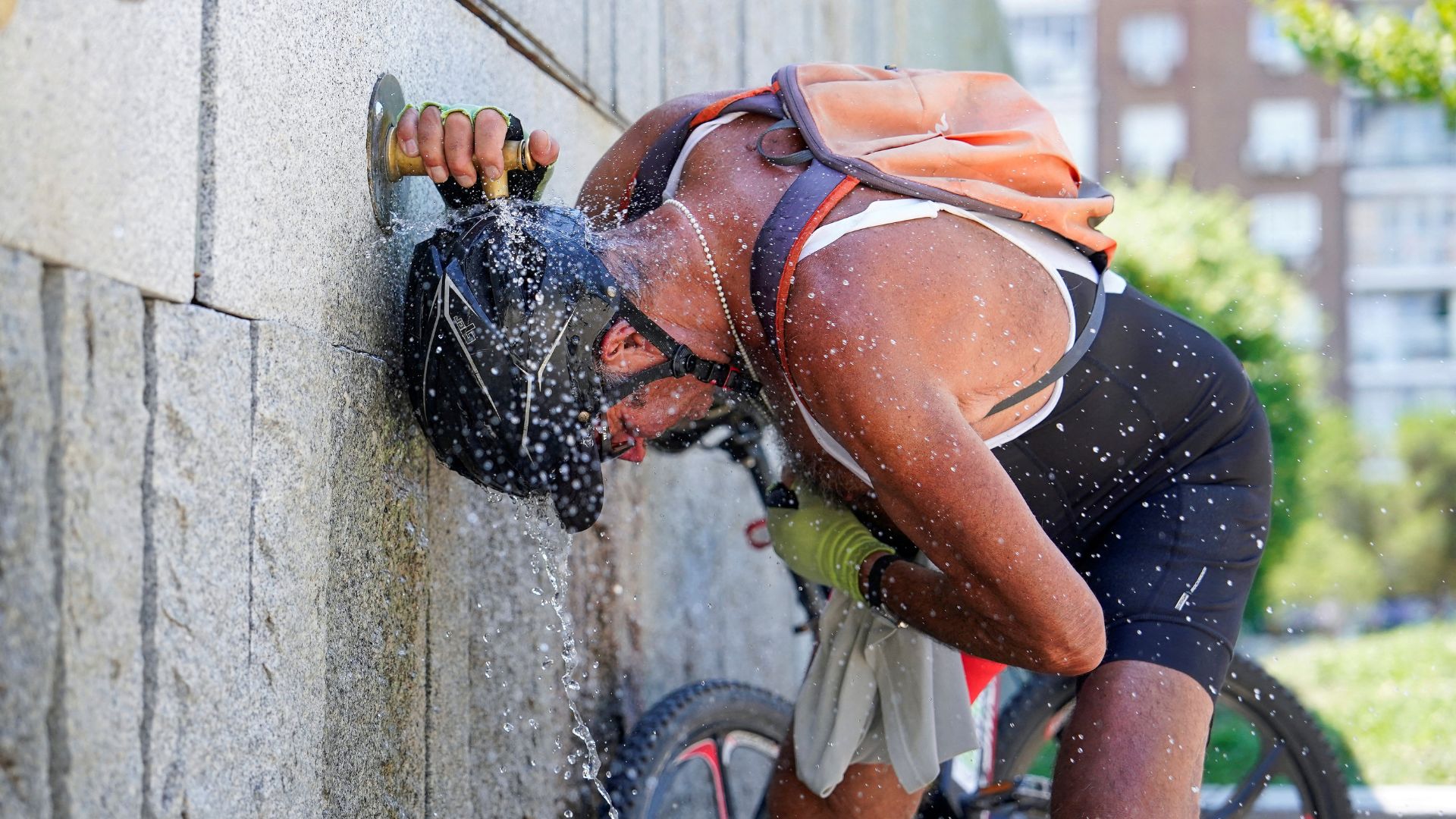 A cyclist cools off at a fountain during the second day of the heatwave, in Madrid, Spain, in July 25. /Ana Beltran/Reuters