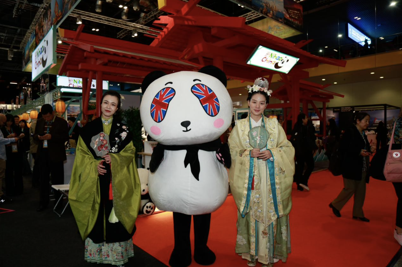 People in traditional Chinese attire pose at the China Pavilion during the 2024 World Travel Market in London. /CGTN