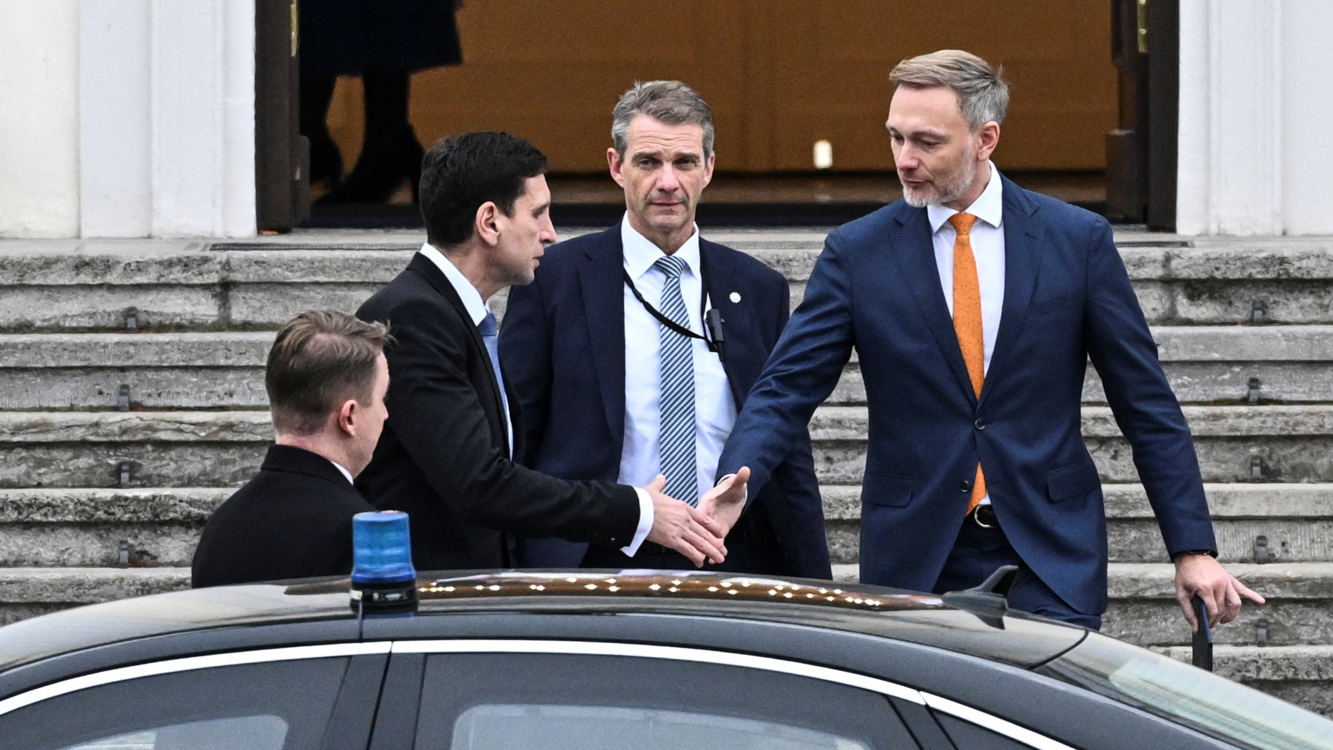 Outgoing German Finance Minister Lindner (orange tie) leaves the Bellevue Castle in Berlin after his sacking. /Annegret Hilse/Reuters
