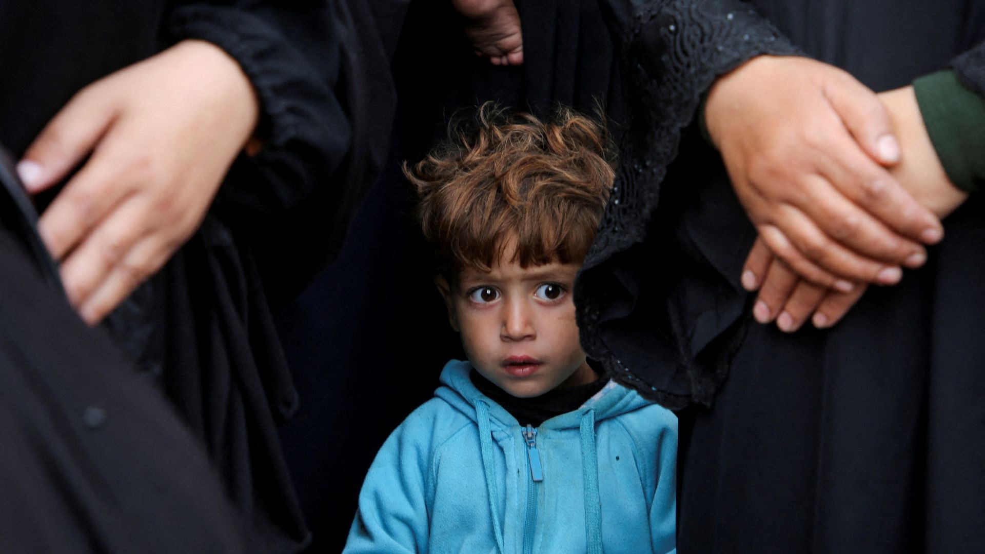 A child looks on as people mourn Palestinians killed in Israeli strikes, at Nasser hospital in Khan Younis in the southern Gaza Strip. /Hatem Khaled /Reuters