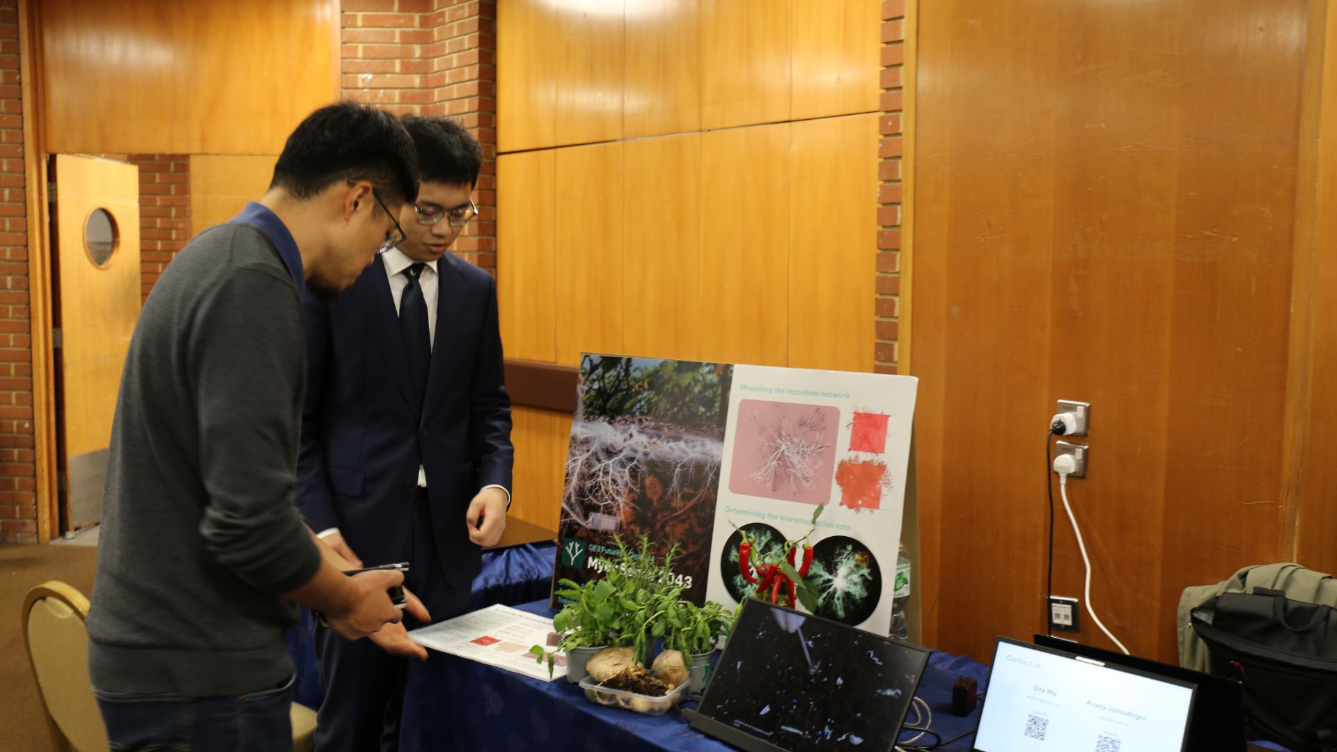 Two students from the Dyson School of Design and Engineering at Imperial College London demonstrate a data-driven system called myrosinase, which aims to help farmers detect and remediate pollution autonomously. /Jian Feng/CGTN