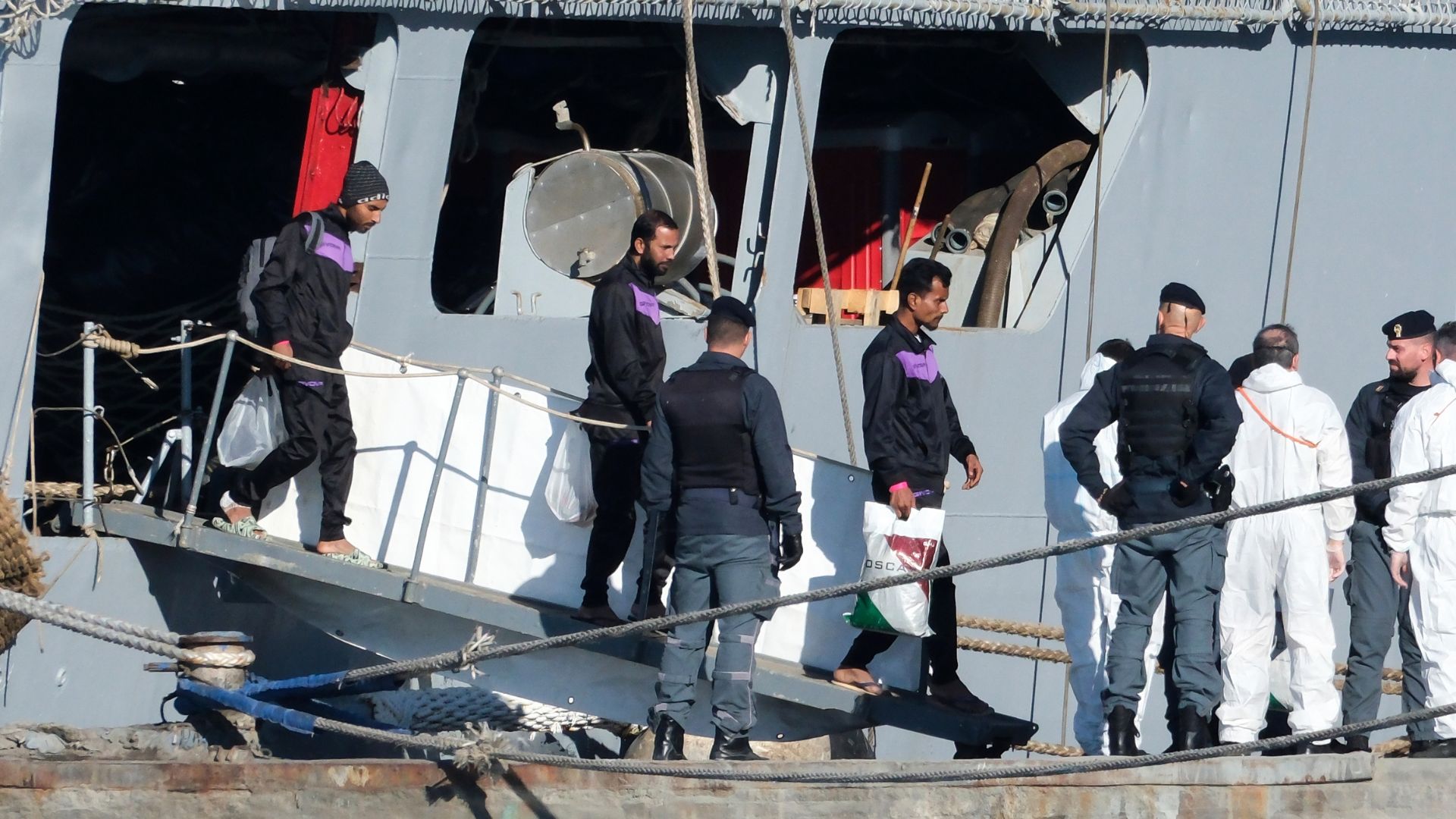 Migrants disembark from the Italian navy ship Libra in Albania, last Friday – but they've been sent back to Italy. /Vlasov Sulaj/AP
